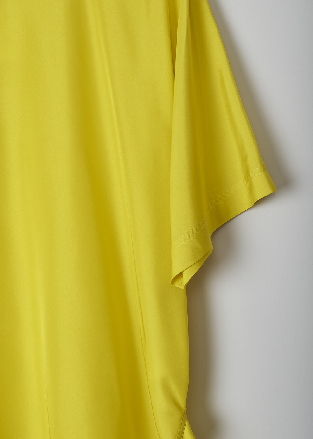 SOFIE D’HOORE, BRIGHT YELLOW SILK TOP, BAGEL_SOHO_BUTTERCUP, Yellow, Detail, The bright yellow silk top has a round neckline and short sleeves. The top has a rounded hemline with an asymmetrical finish, meaning the back is a little longer than the front. 

