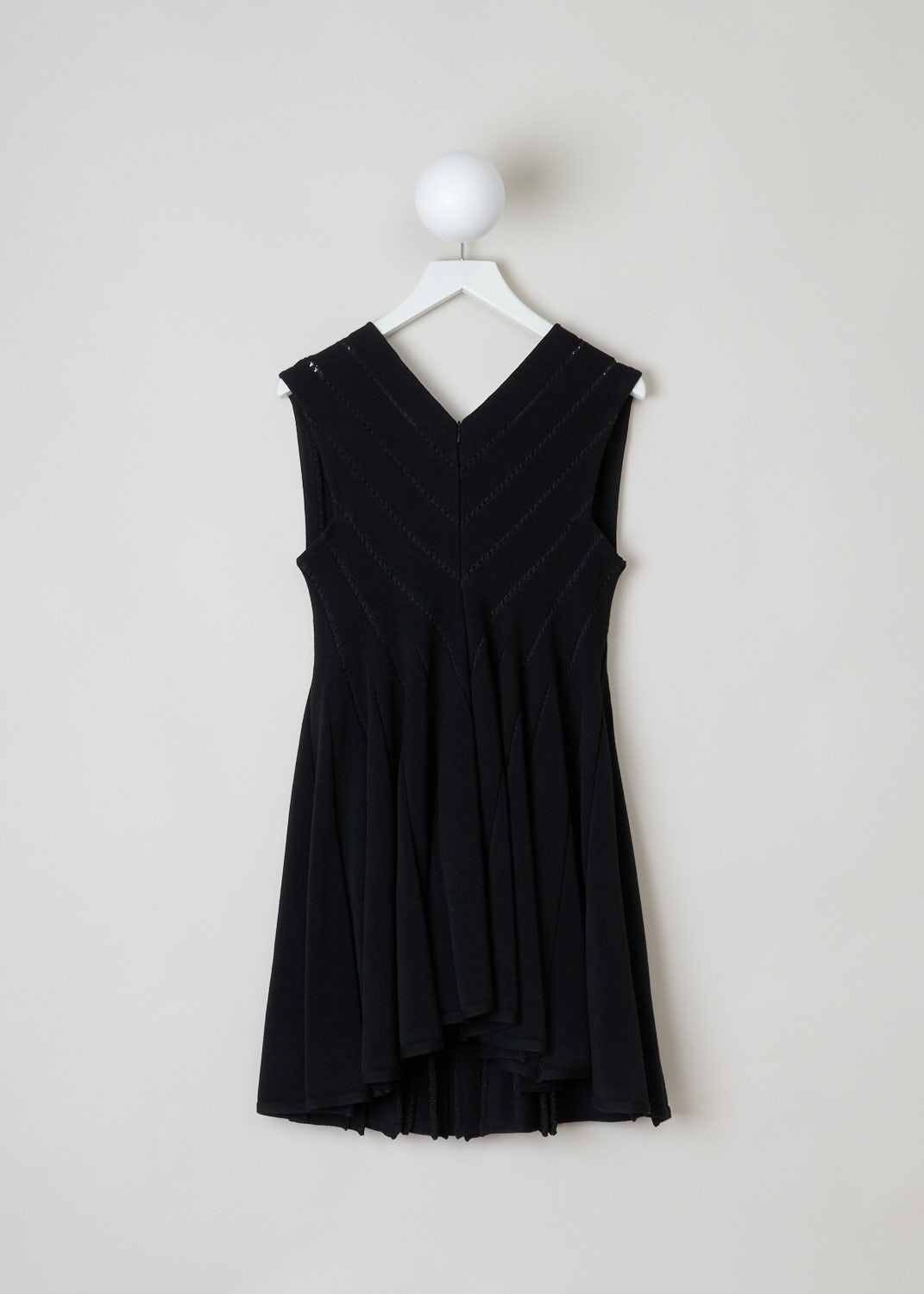 AlaÃ¯a, Black babydoll dress with embroidered detailing, 4W9RB20CM120_baby_doll_SM_noir_C999, black, back, Black babydoll dress featuring a square cut neckline on the front and a v-shape on the back. The top of this dress is put together in strips of fabric held together by the black embroidery. The skirt of this model is designed with knife pleats and will flare out. The length of this model is thigh-height. Your fastening option on this model is the concealed zipper on the back.  