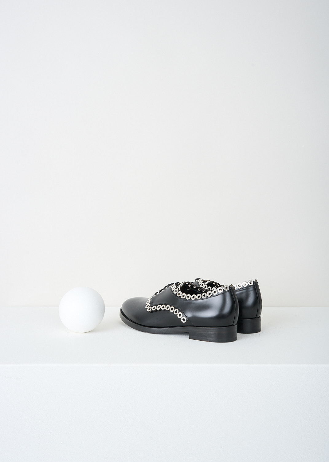 Alaïa, Black derby shoes with silver detailing, 6W3D064CG19_C999_NOIR, Black, Back, These black leather derby shoes have a round toe, a classic lace-up closing with black laces and a small heel. Silver-toned rings run along the seams.
