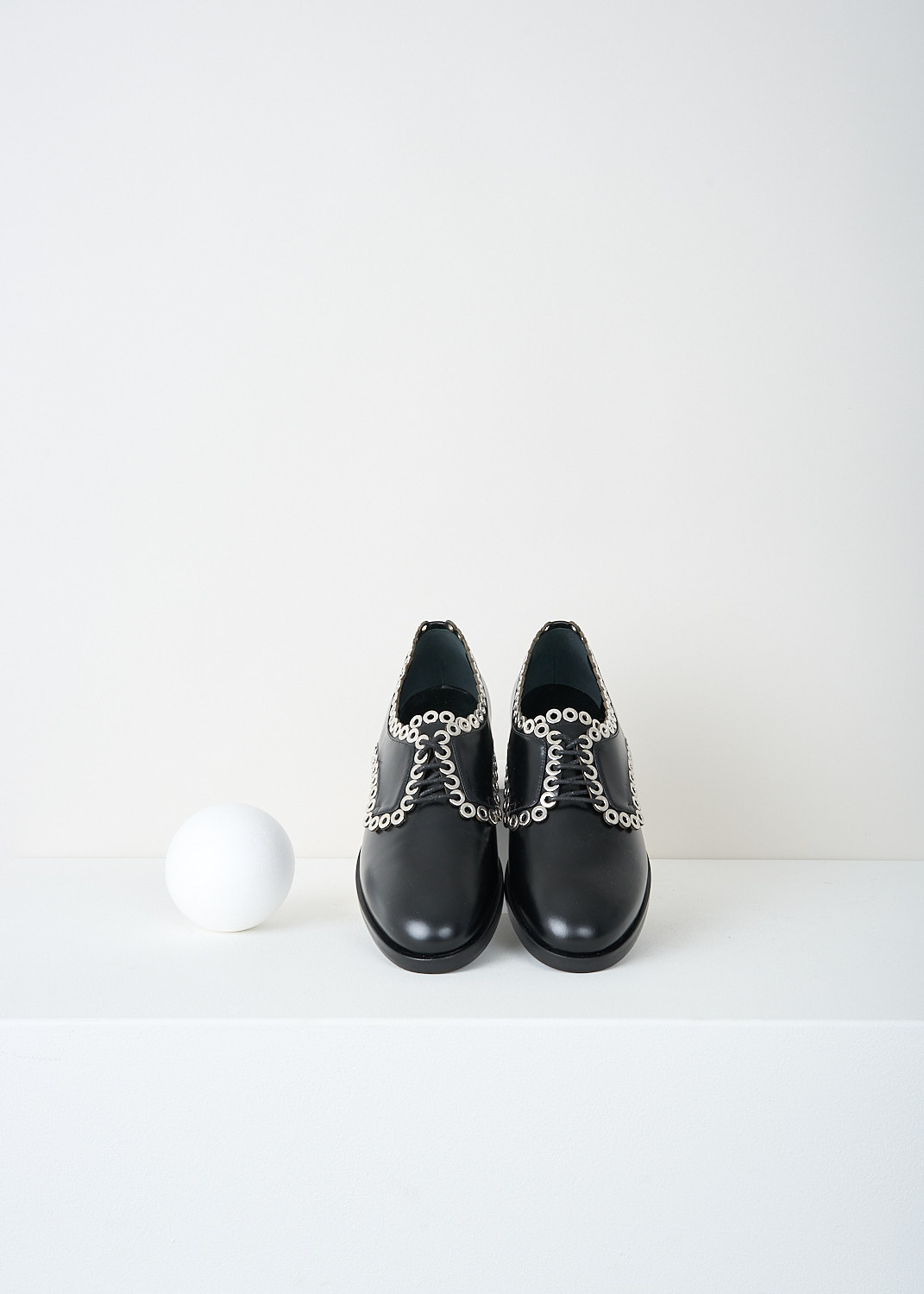 Alaïa, Black derby shoes with silver detailing, 6W3D064CG19_C999_NOIR, Black, Top, These black leather derby shoes have a round toe, a classic lace-up closing with black laces and a small heel. Silver-toned rings run along the seams.
