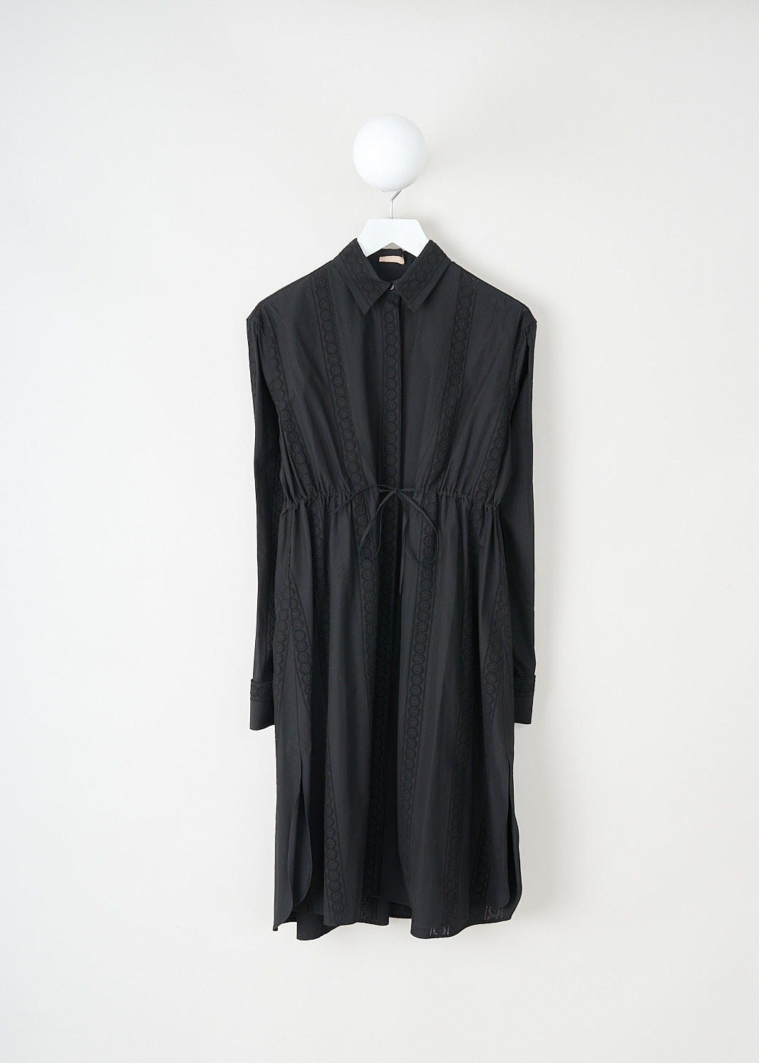 Alaïa, Black broderie anglaise shirt dress, 8S9C010LT200_C999_NOIR, Black, Front, This black shirt dress has a classic collar and a concealed front button closure. The long sleeves have buttoned cuffs. The drawstring can be tied in a bow and can be used to cinch in the waist. Broderie anglaise-trims decorate the whole of the dress.
