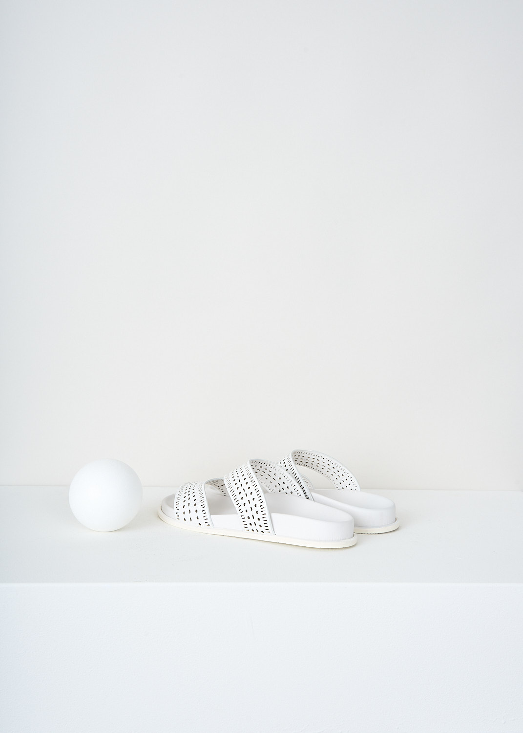 Alaïa, White leather slides with laser-cut straps, AA3M022CK035_006_BLANC_CRAIE, White, Back, These white leather slides have two laser-cut straps.
