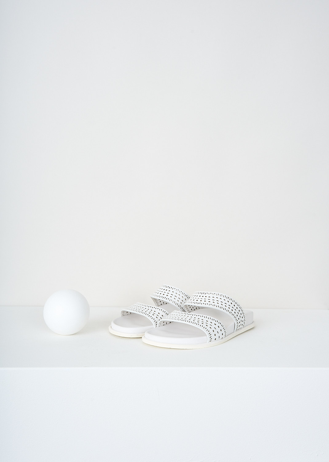 Alaïa, White leather slides with laser-cut straps, AA3M022CK035_006_BLANC_CRAIE, White, Front, These white leather slides have two laser-cut straps.
