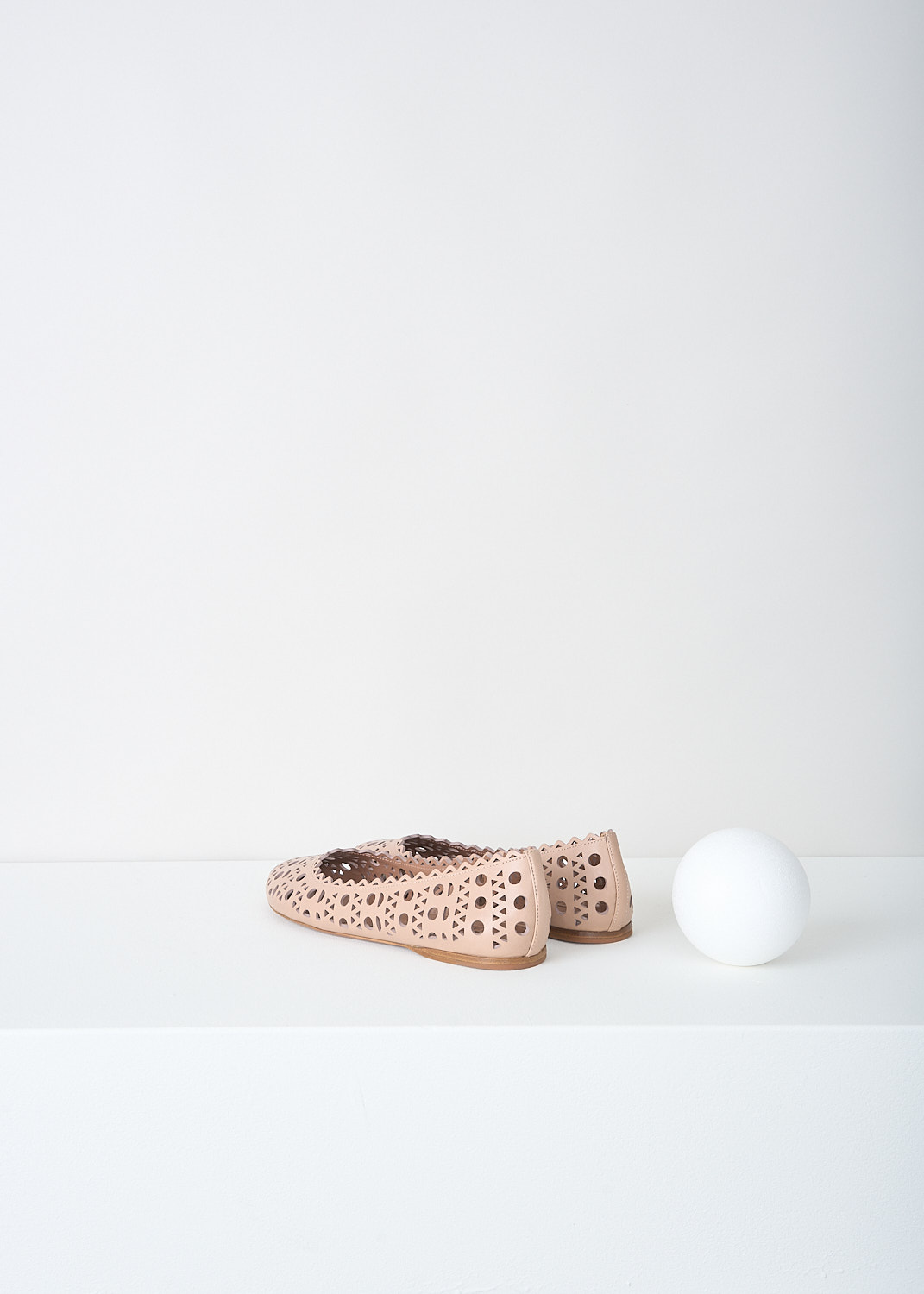 Alaïa, Nude leather ballerina flats with laser-cutouts, AS3F326CE77_C117_CHAIR, Beige, Back, These nude leather ballerina flats have a round toe. These open-work flats have Vienne laser-cutouts throughout and have a serrated top edge.  
