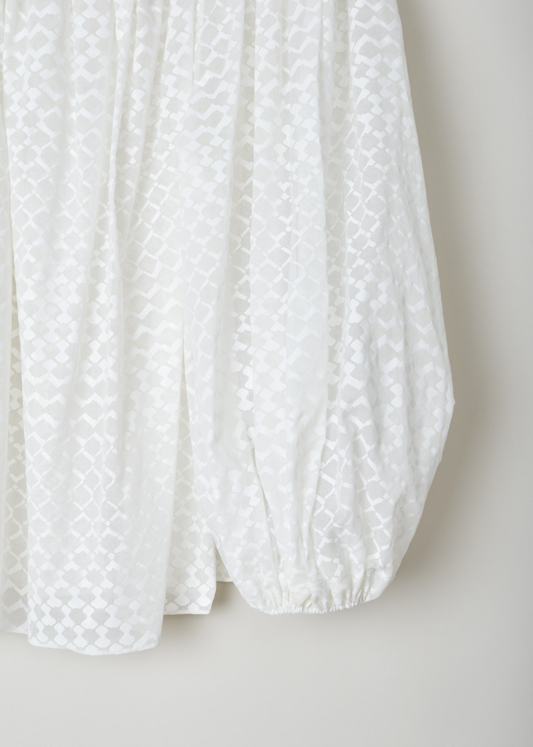 Alaïa, Slightly see-through oversized top in white, AS9U213RT314_C000_blanc, white, detail, A lovely oversized top decorated with a white lozenge motif. Made entirely from a thinly woven cotton, making this top slightly see through. Furthermore, this model comes with a boat neckline which leads into the long balloon sleeves.