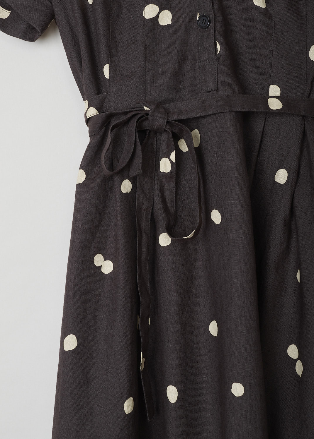 ASPESI, BROWN LINEN MAXI DRESS WITH DOTTED PRINT, 2958_M277_62331, Brown, Print, Detail, This chocolate brown linen dress has a off-white dotted print throughout. The dress has a modest V-neckline and w three-button closure in the front. The dress has short sleeves with rolled cuffs. An attached belt can be used to cinch in the waist. A concealed side zip functions as the closure option. Slanted pockets re concealed in the side seam. The dress has a straight hemline.
