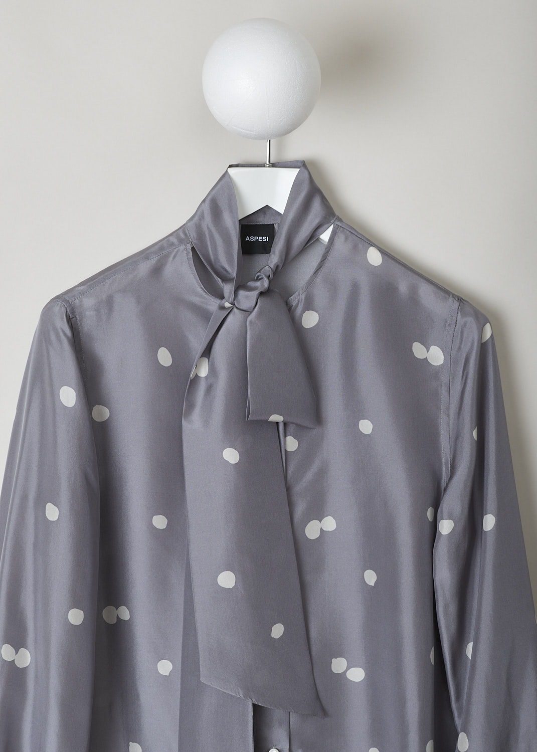 ASPESI, GREY SILK BLOUSE WITH PUSSY BOW, 5448_M278_62187, Grey, Print, Detail, This grey silk blouse has a pale grey dotted print. The blouse has a pussy bow collar and front button closure. The long bishop sleeves have elasticated cuffs. The blouse has a rounded hemline with small slits.
