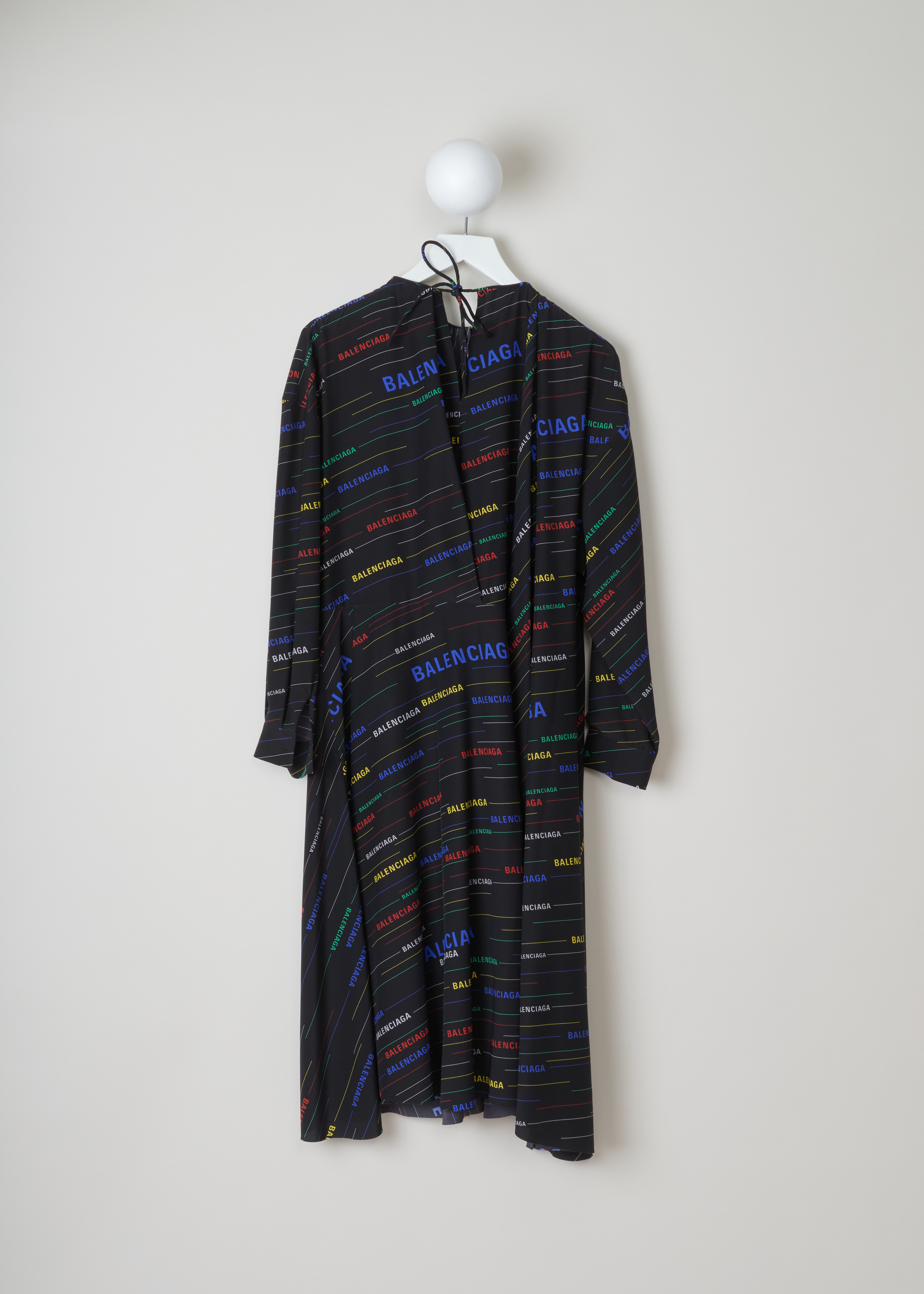 Balenciaga Logo printed dress 556343_TDL55_2771 black multicolour back. Black silk dress with multicolour diagonal logo print, gathered rounded neckline, buttoned cuffs and a self-tie bow fastening on the back.