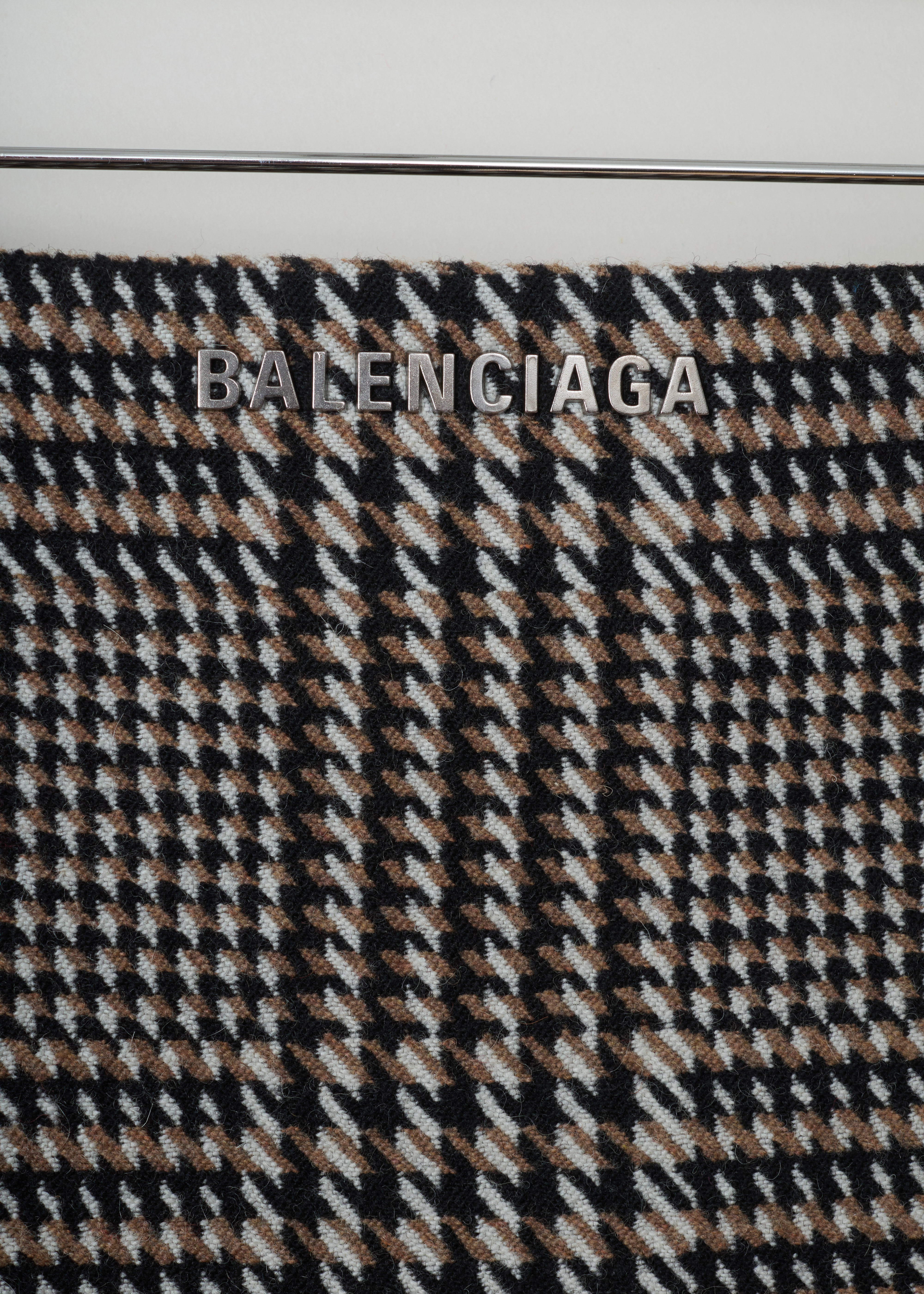 Balenciaga Tweed pencil skirt 528505_TBU21_2684 brown black detail. Pencil skirt in brown, black and white tweed with a tailored fit, Balenciaga logo printed on the front, centre back split and an invisible zipper fastening at the back.