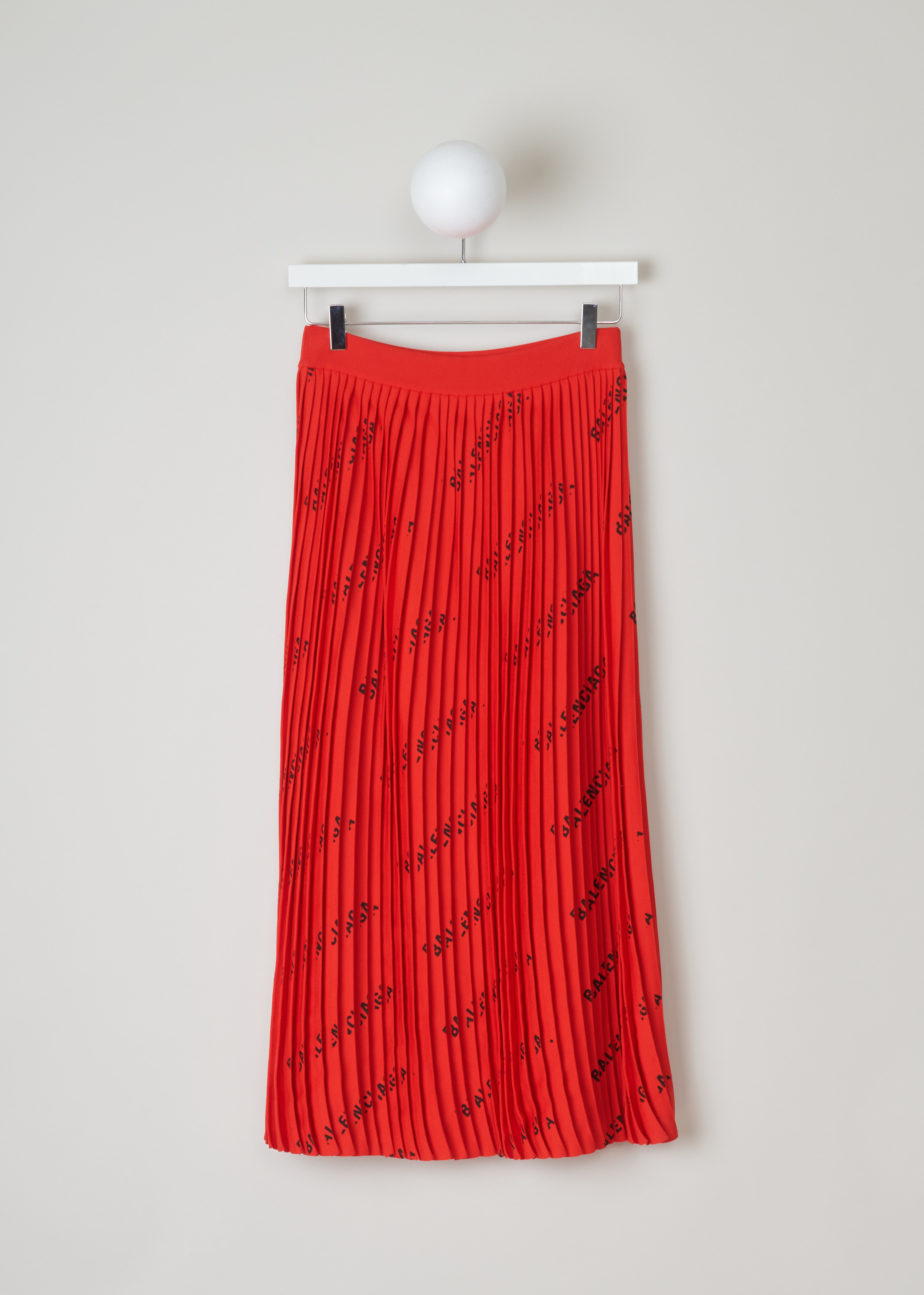 Balenciaga Plissé skirt with logo pattern 570845_T6140_6282 red back. Midi length plissé skirt with an all over logo print of the Balenciaga logo and an elasticated waistband.