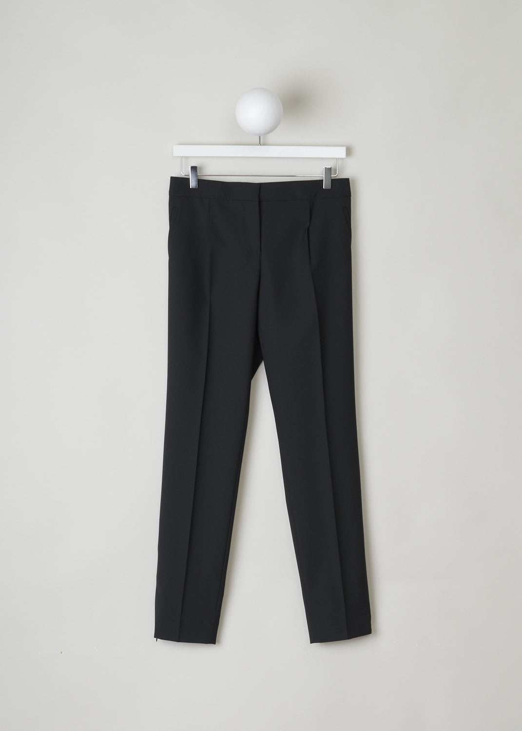 BALENCIAGA, CLASSIC BLACK PANTS WITH SUBTLE ZIPPER DETAIL, 329181_TCJ69_1000, Black, Front, This classic black pants has front creases along the length of the legs. These same creases can also be found on the back of the legs. On the front, welt pockets can be found on either side. On the ends of the legs, concealed zippers can be found that open to about ankle height.
