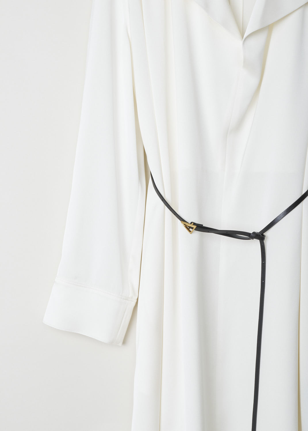 BOTTEGA VENETA, WHITE SILK DRESS WITH CONTRASTING BELT, 606454_VKJ90_8329, White, Detail, This silky smooth, long sleeved dress has a deep V-neck with an exaggerated pliable collar. Across the shoulders, dainty little pleats can be found. The dress comes with a thin, contrasting black belt in leather, with its belt buckle being the recognizable gold-toned triangle.  
