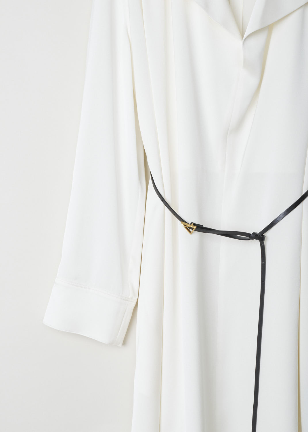 BOTTEGA VENETA, WHITE SILK DRESS WITH CONTRASTING BELT, 606454_VKJ90_8329, White, Detail, This silk long-sleeve dress has a deep V-neck with an exaggerated collar. Across the shoulders, dainty little pleats can be found. The dress comes with a thin, contrasting black leather belt with a gold-tone triangle belt buckle. 