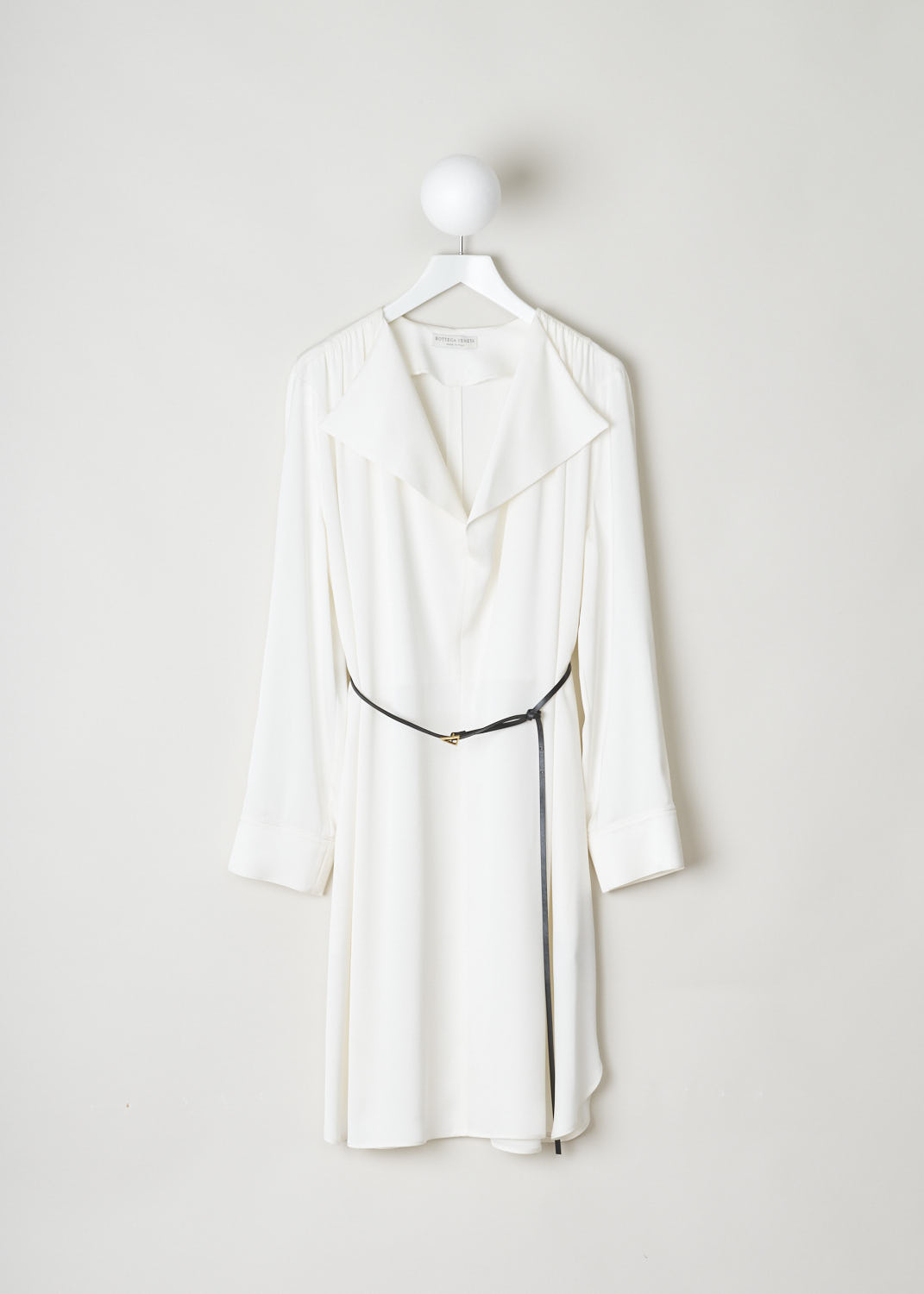 BOTTEGA VENETA, WHITE SILK DRESS WITH CONTRASTING BELT, 606454_VKJ90_8329, White, Front, This silky smooth, long sleeved dress has a deep V-neck with an exaggerated pliable collar. Across the shoulders, dainty little pleats can be found. The dress comes with a thin, contrasting black belt in leather, with its belt buckle being the recognizable gold-toned triangle.  
