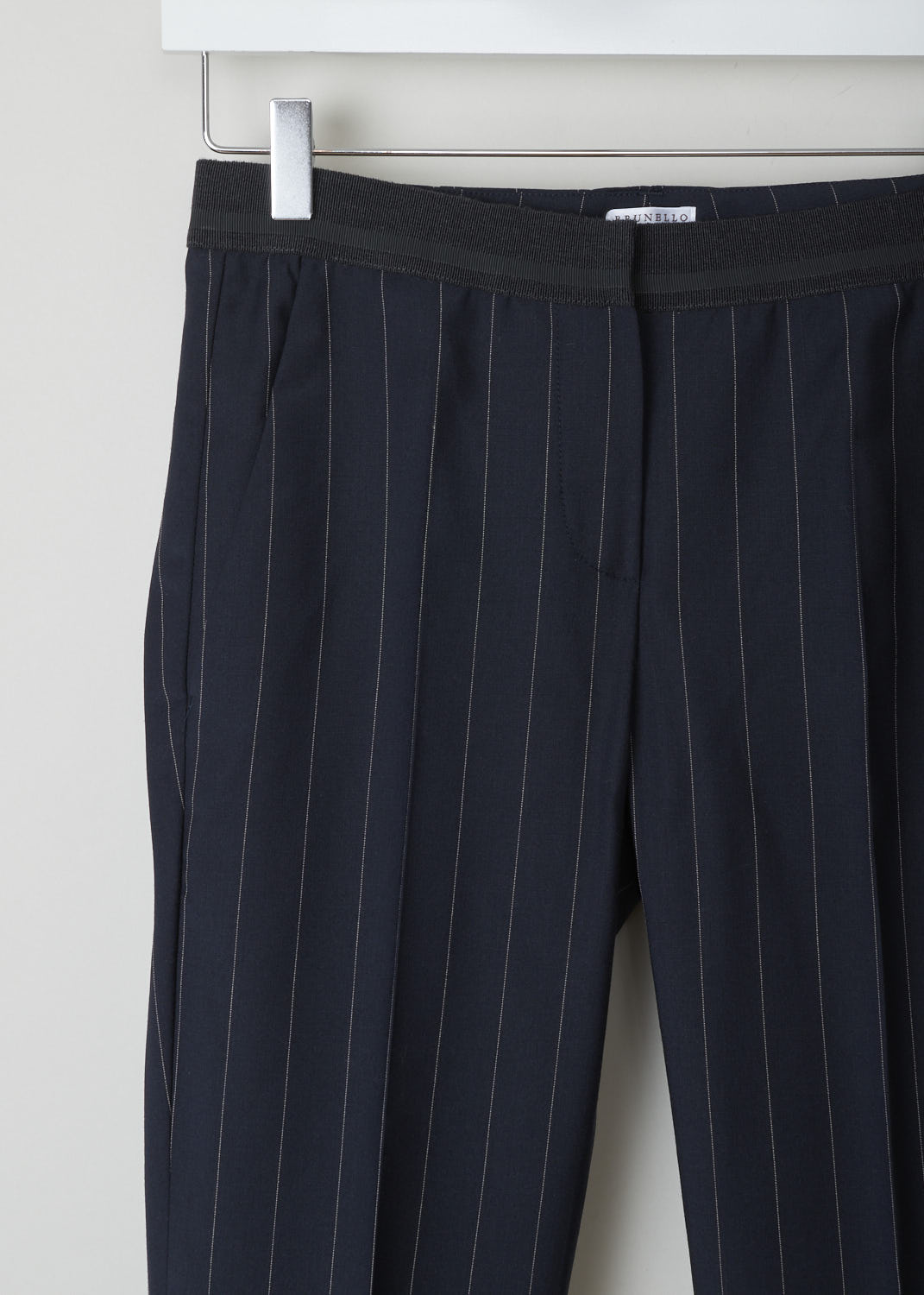 BRUNELLO CUCINELLI, NAVY BLUE TROUSERS WITH PINSTRIPE, M0H35P1500_C6009, Blue, Detail, These navy blue pinstripe trousers are made of a wool blend. Featuring a partly elasticated waistline, forward slanted pockets in the front, and two buttoned welt pockets in the back. Along the length of the pant leg, centre creases can be found. These trousers have a folded hem.
