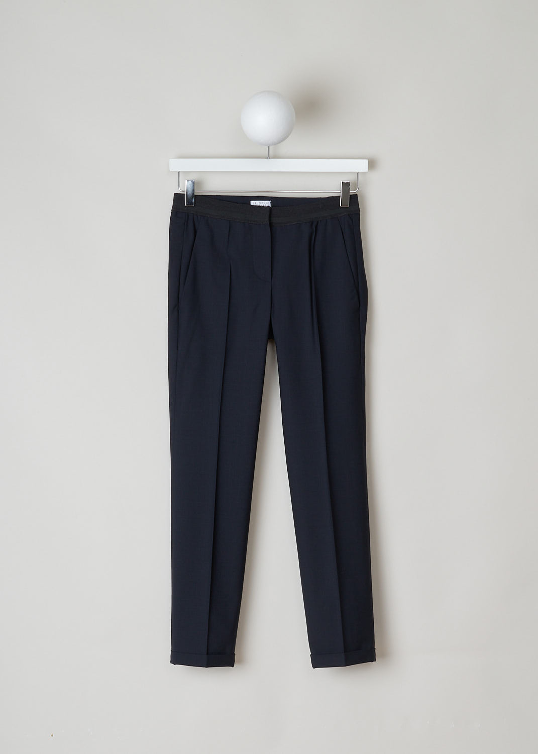 BRUNELLO CUCINELLI, NAVY BLUE PANTS WITH PARTY ELASTICATED WAISTBAND, M0W07P1500_C060, Blue, Front, Navy blue pants with partly elasticated waistline. A clasp and zipper function as the closing option. The pants feature forward slanted pockets in the front, and two buttoned welt pockets in the back. Along the length of the pant leg, centre creases can be found. These pants have a folded hem.
