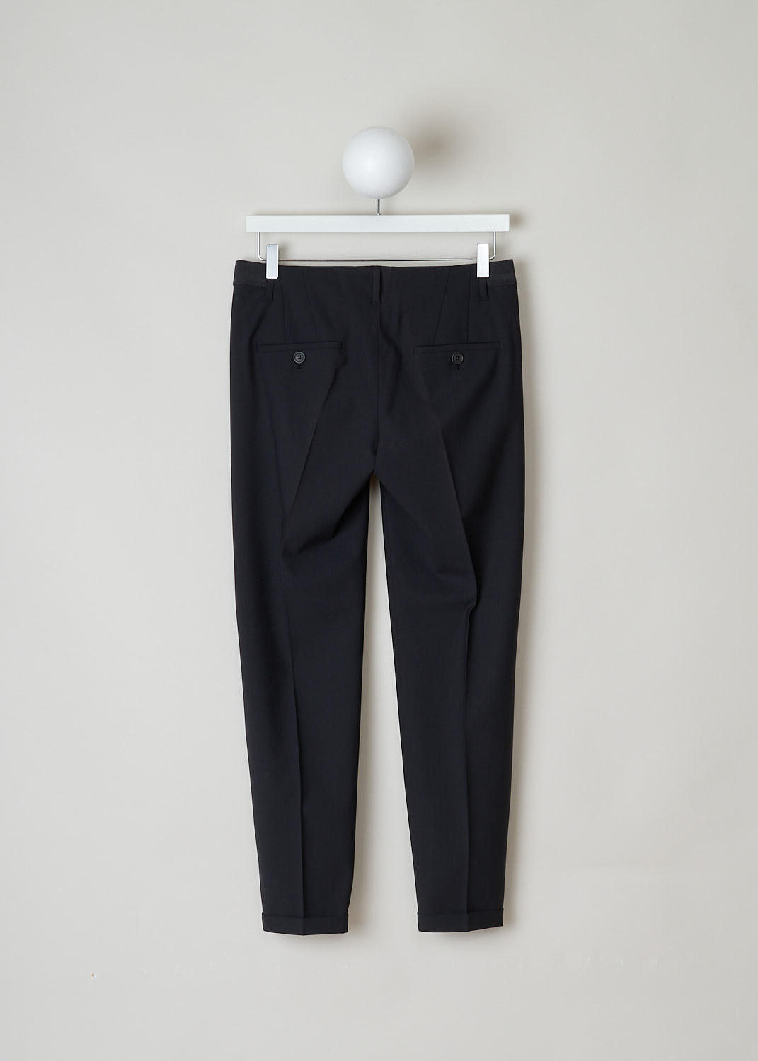 BRUNELLO CUCINELLI, BLACK PANTS WITH PARTLY ELASTICATED WAISTBAND, M0W07P1500_C101_M, Black, Back, Black pants with partly elasticated waistline. A clasp and zipper function as the closing option. The pants feature forward slanted pockets in the front, and two buttoned welt pockets in the back. Along the length of the pant leg, centre creases can be found. These pants have a folded hem.
