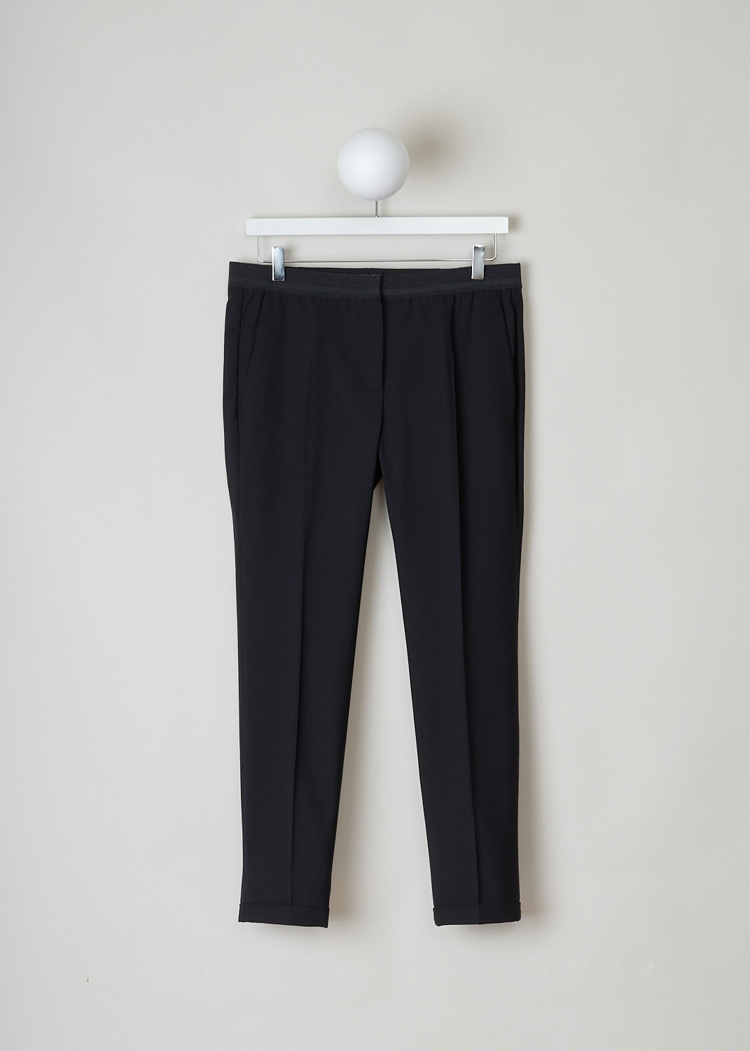 BRUNELLO CUCINELLI, BLACK PANTS WITH PARTLY ELASTICATED WAISTBAND, M0W07P1500_CD531, Black, Front, These black pants have a partly elasticated ribbed waistline with with a decorative horizontal stripe. These pants have two belt loops on the backside. A concealed clasp and zipper function as the closing option. The pants have forward slanted pockets in the front and two buttoned welt pockets in the back.The tapered pant legs have centre creases. These pants have a folded hem.
