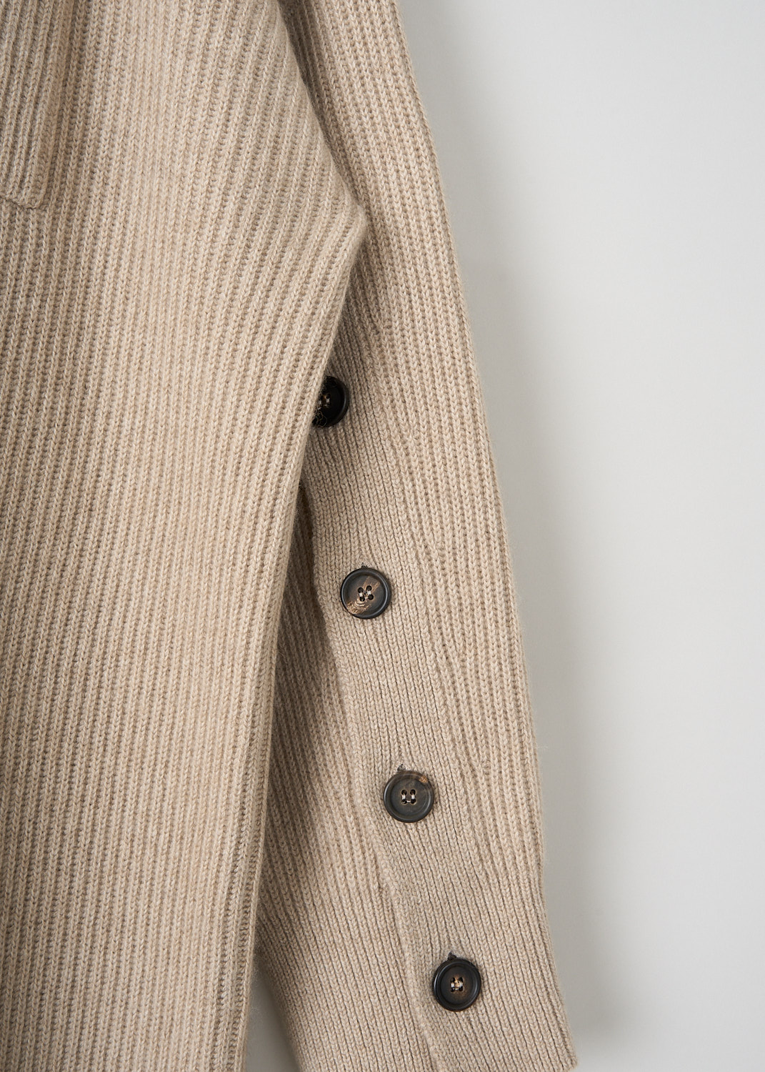 Brunello Cucinelli, Beige rib knit dress with buttoned sleeves, M12714A94_C077, Beige, Detail, This beige rib knit dress has a round neckline and long sleeves with buttons on the inside of the arm. On the front, the dress has a single breast pocket. The dress has a straight hemline. 

