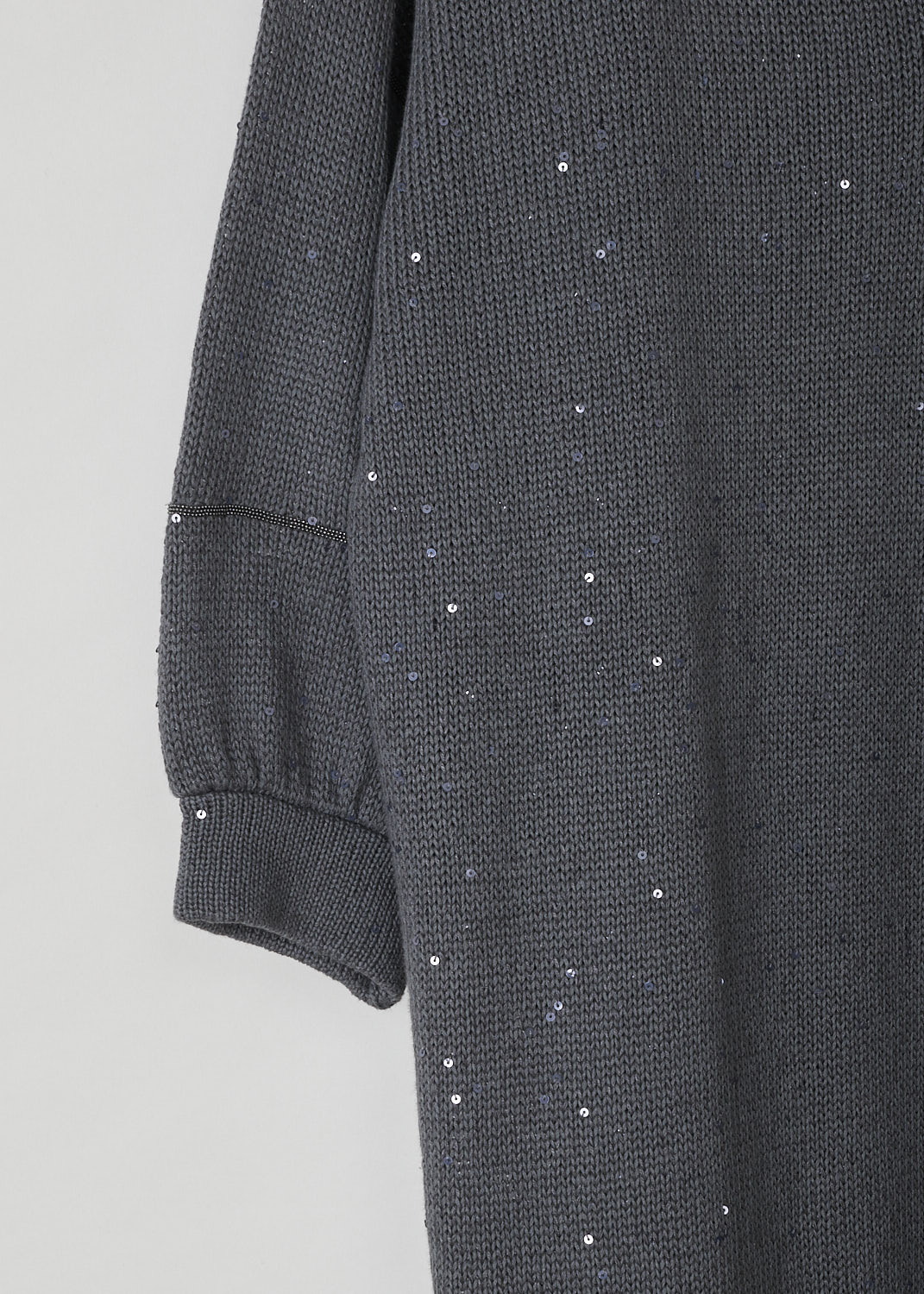 BRUNELLO CUCINELLI, GREY KNITTED SWEATER DRESS WITH SEQUINS, M70573A82_CJ079, Grey, Detail, This grey knitted sweater dress has a V-neckline, dropped shoulders and three-quarter sleeves. The neckline, cuffs and hemline have a ribbed finish. The dress has sequins sewn in throughout and along the shoulders and across the sleeves, monili beaded strips can be found. The dress has a wider silhouette.  
