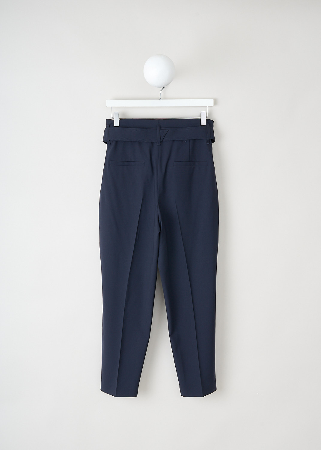 Brunello Cucinelli, Navy blue wool pants with matching belt, MA105P6899_C1359, Blue, Back, These navy blue wool pants have an elasticated waist, a concealed clasp and zipper closure and a matching fabric belt with a brown leather buckle. These pants have a pleated front and tapered pant legs with centre creases. In the front, slanted pockets can be found. In the back, these pants have welt pockets. 

