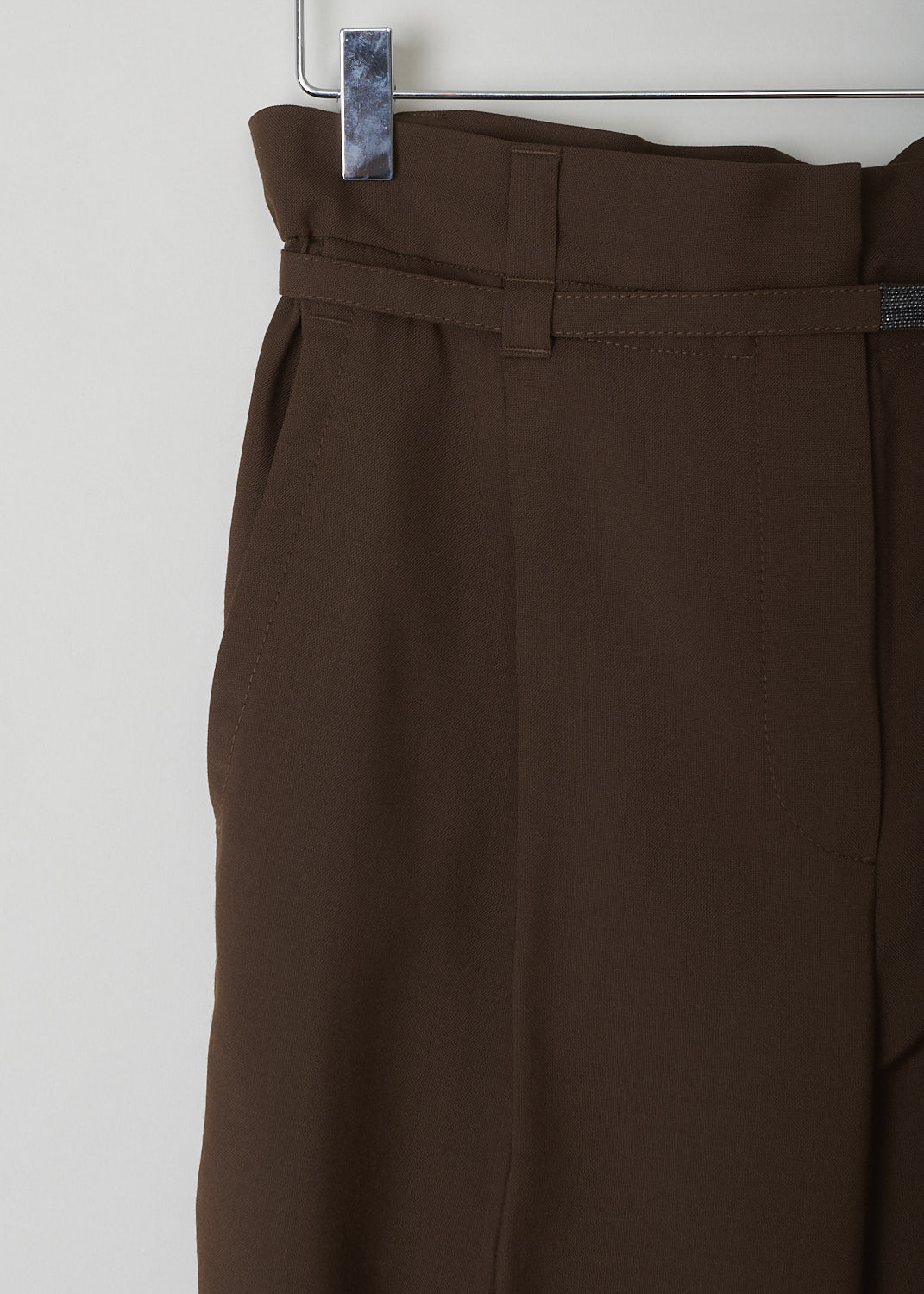 BRUNELLO CUCINELLI, BROWN PAPERBAG PANTS, MA185P7461_C8517, Brown, Detail1, These brown pants have a paperbag waist which is half elasticated. These pants come with both a broad and a narrow belt loop. A narrow fabric belt with monili beading is included. A concealed snap button and zipper function as the closure option. These pants have tapered pant legs with centre creases. Slanted pockets can be found in the front and welt pockets in the back.
