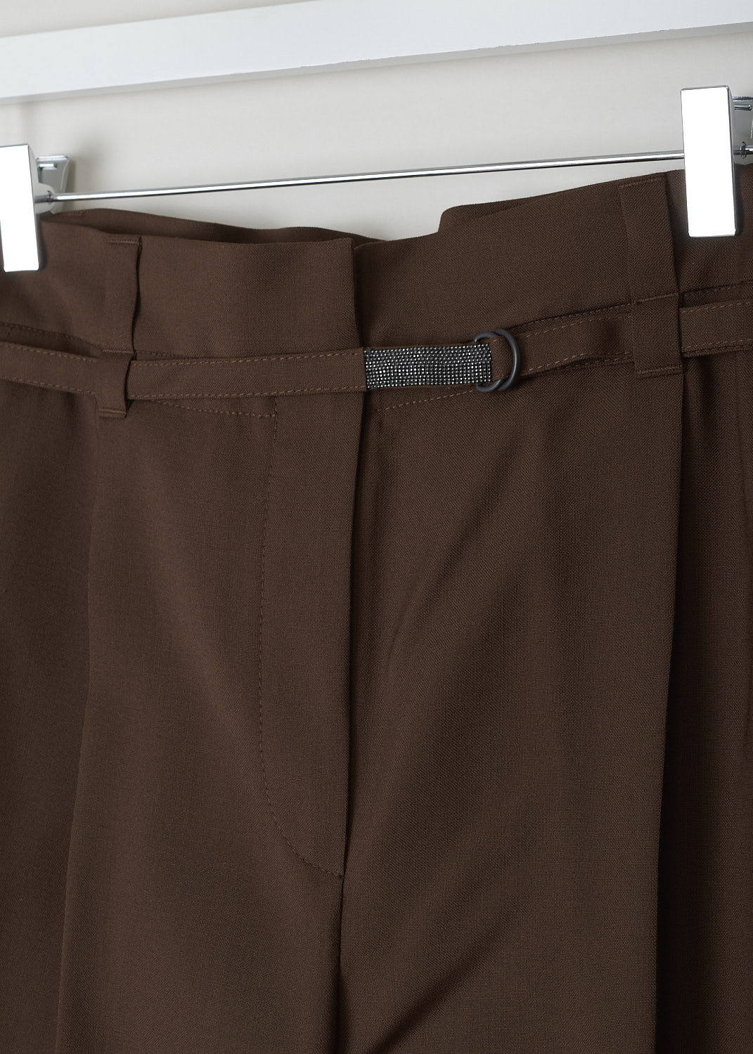 BRUNELLO CUCINELLI, BROWN PAPERBAG PANTS, MA185P7461_C8517, Brown, Detail, These brown pants have a paperbag waist which is half elasticated. These pants come with both a broad and a narrow belt loop. A narrow fabric belt with monili beading is included. A concealed snap button and zipper function as the closure option. These pants have tapered pant legs with centre creases. Slanted pockets can be found in the front and welt pockets in the back.
