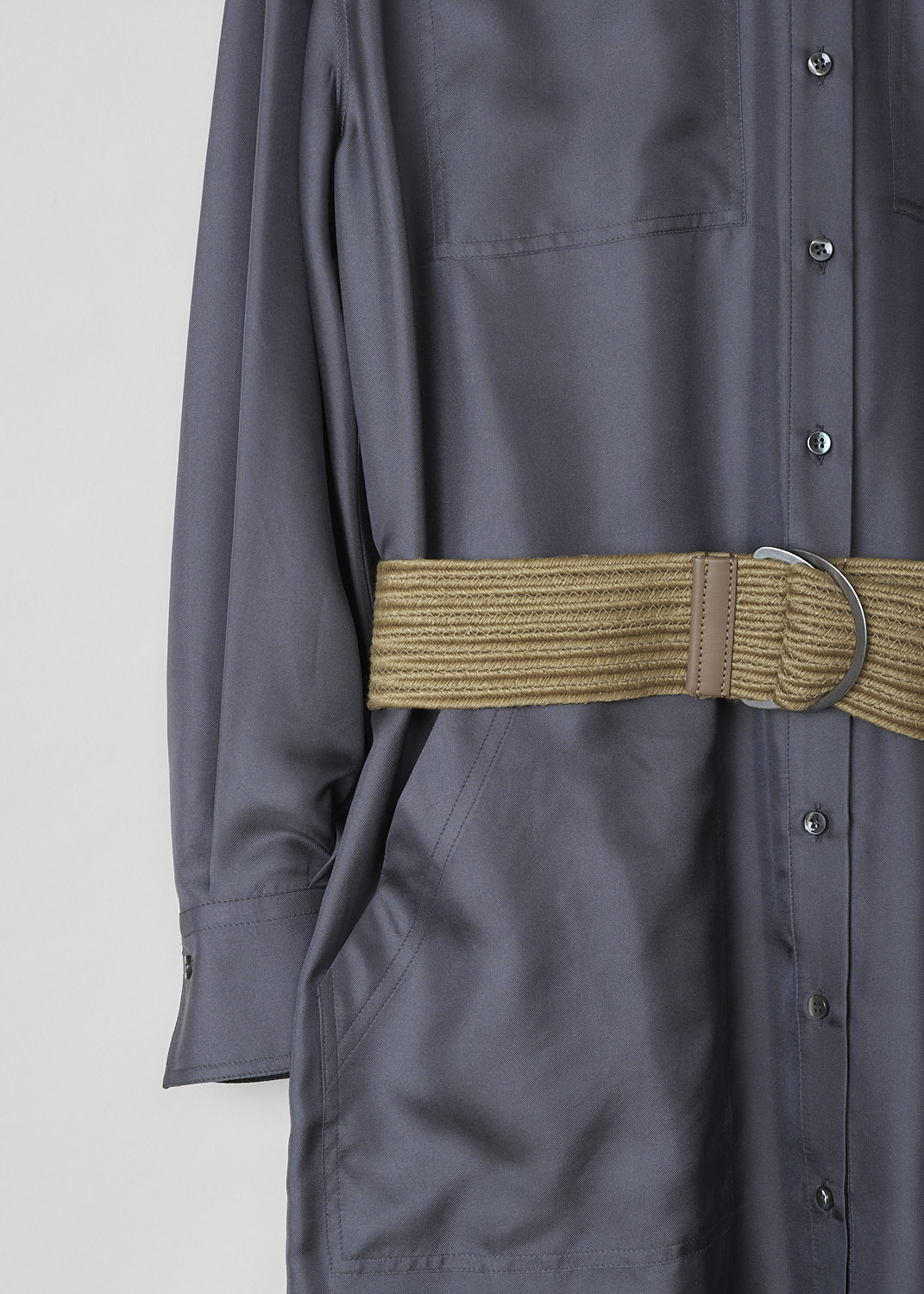 BRUNELLO CUCINELLI, ANTHRACITE SHIRT DRESS WITH BRAIDED BELT, MB953MY306_C079, Grey, Detail, This wide anthracite shirt dress has a classic collar a front button closure. The long sleeves have buttoned cuffs. The dress has four stitched on pockets: two monili decorated breast pockets with flap and two slanted patch pockets. The dress has a rounded hemline with an asymmetrical finish, meaning the back is a little longer than the front. The dress comes with braided belt.
