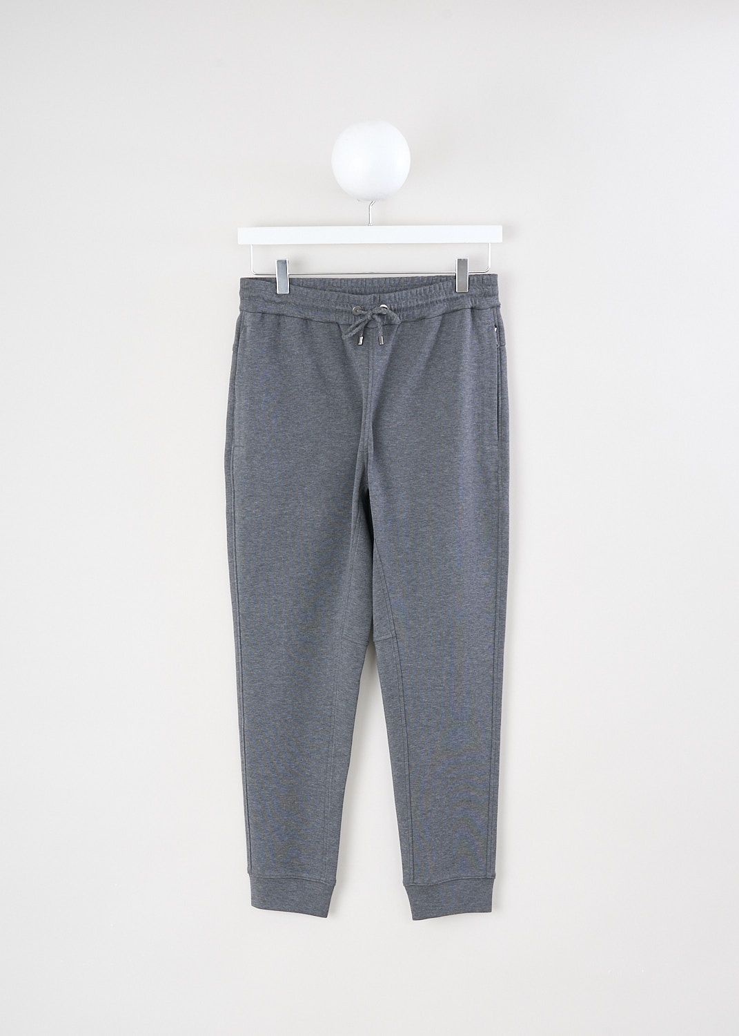 Brunello Cucinelli, Heather grey sweatpants with zipped pockets, MB982SG499_C080, Grey, Front, These heather grey pants have a elasticated waistband with a drawstring to cinch in the waist. Concealed in the seam, these pants have zipped slanted pockets. The tapered pant legs have ankle cuffs. In the back, the pants have a single welt pocket with subtle monili detailing.