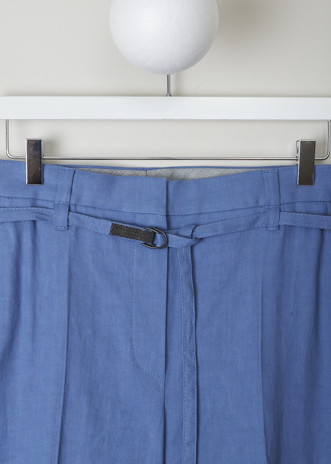 BRUNELLO CUCINELLI, BLUE LINEN PANTS WITH MATCHING BELT, MF591P7453_C8593, Blue, Detail, These blue linen pants have a concealed clasp and zipper closure and a matching fabric belt with a double D-ring buckle. The belt is subtly decorated with Monilli beads. These pants have a pleated front and tapered pant legs with centre creases. In the front, slanted pockets can be found. In the back, these pants have welt pockets. 
