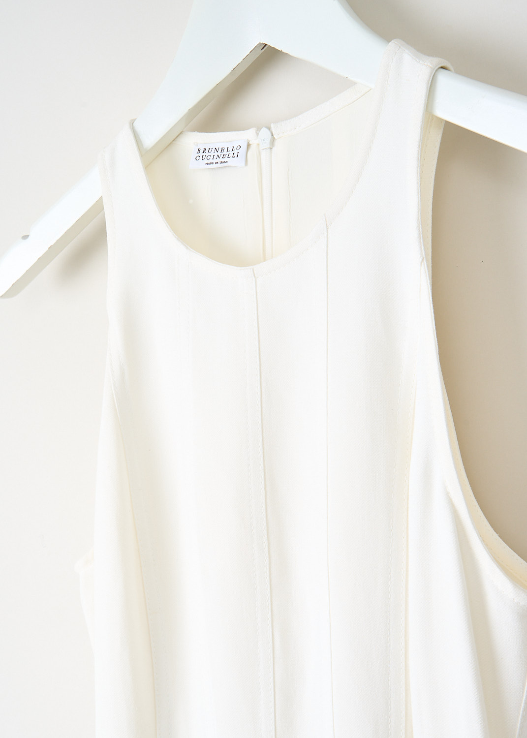 Close-up of Brunello Cucinelli white maxi dress showing the fitted bodice and refined fabric texture.