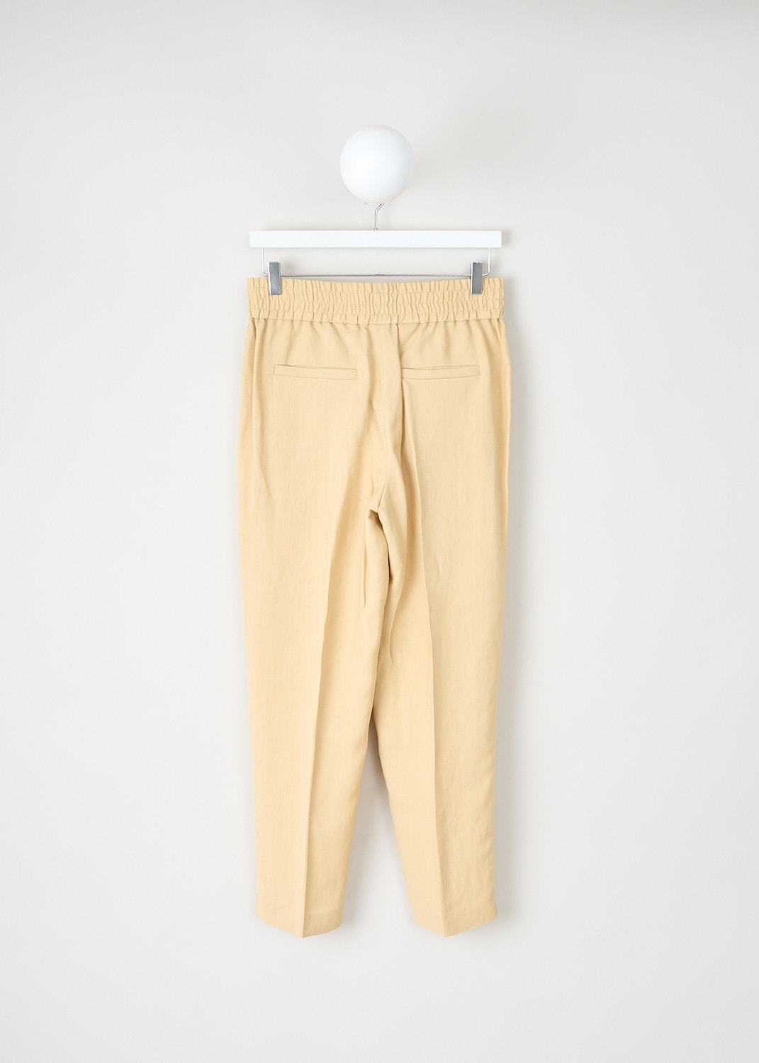 Brunello Cucinelli, Pale yellow jogger-style pants, MH126P7197_C8612, Yellow, Back, These pale yellow jogger-style pants have an elasticated waistband. These pants have slanted pockets in the front and welt pockets in the back. The straight pant legs have pressed creases. Along the sides, broad trims in the same fabric run along the pant legs. 
