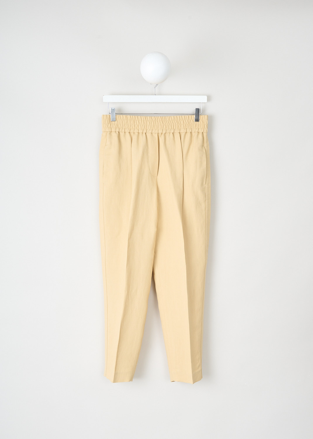Brunello Cucinelli, Pale yellow jogger-style pants, MH126P7197_C8612, Yellow, Front, These pale yellow jogger-style pants have an elasticated waistband. These pants have slanted pockets in the front and welt pockets in the back. The straight pant legs have pressed creases. Along the sides, broad trims in the same fabric run along the pant legs. 
