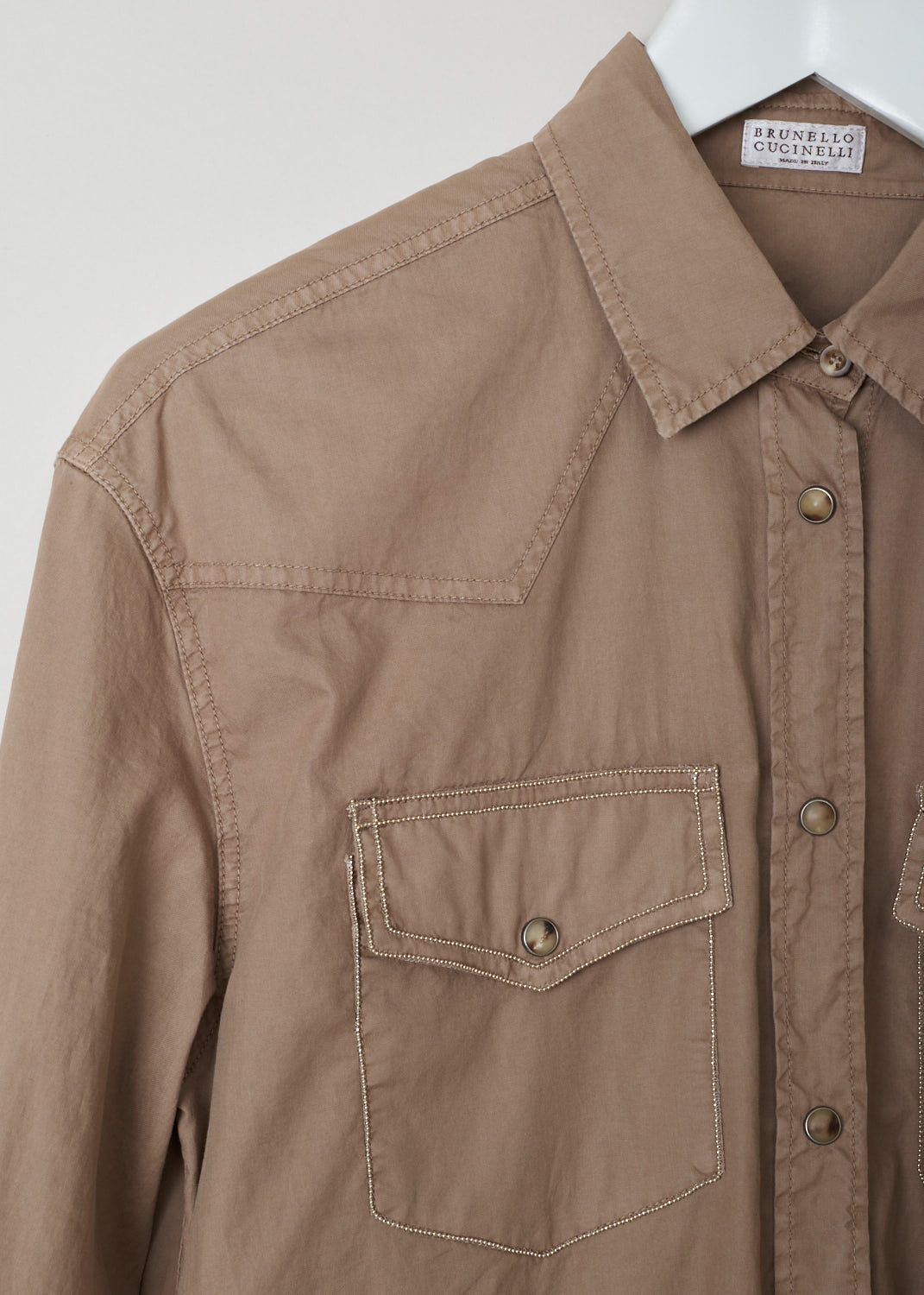 Brunello Cucinelli, Brown shirt dress, ML680AR321_C6067, Brown, Detail, This brown shirt dress features a pointed collar, a front button closure and long sleeves with buttoned cuff. The dress has a two breast pockets that are decorated with monili trims. The dress has a broad pleated hemline. 