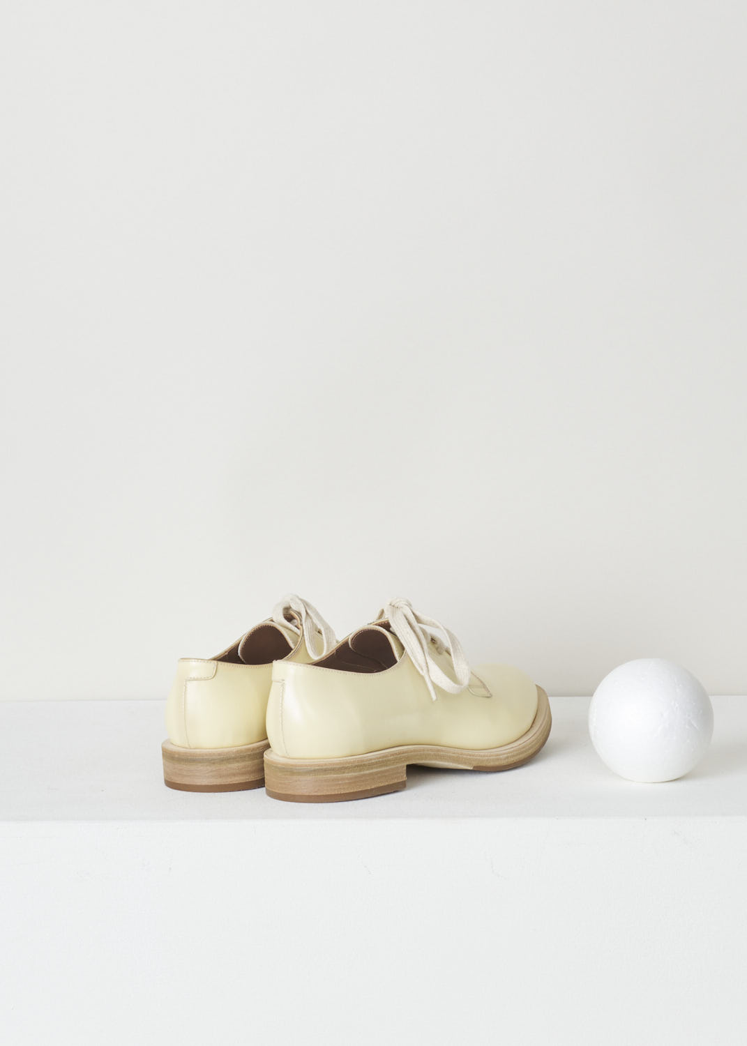 BRUNELLO CUCINELLI, PALE YELLOW DERBY SHOE, MZDVLC113_C6059, Yellow, Back, Pale yellow leather derby shoes with a shiny finish. This model has a classic lace-up closure. These shoes have a rounded toe. The sole is a contrasting dark brown color. 

Heel height: 1.5 cm / 0.5 inch
