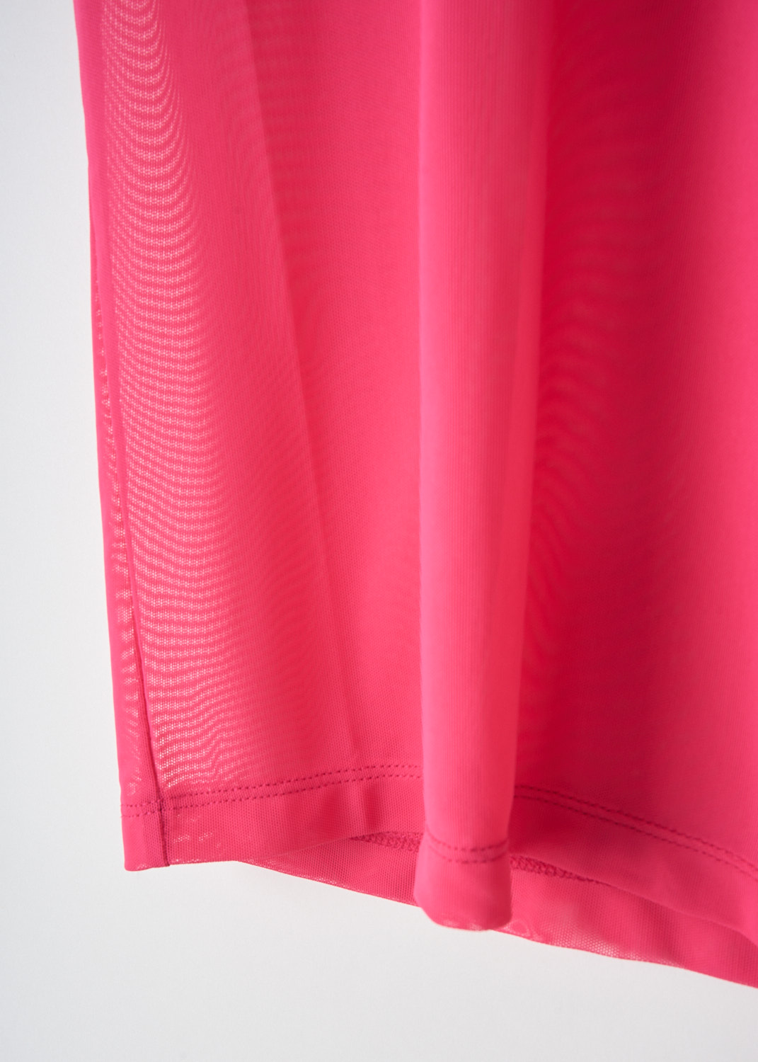 Fabric detail of the bright pink mesh top by designer Caroline Bosmans on sale in the boutique Kiki's Stocksale in Maastricht