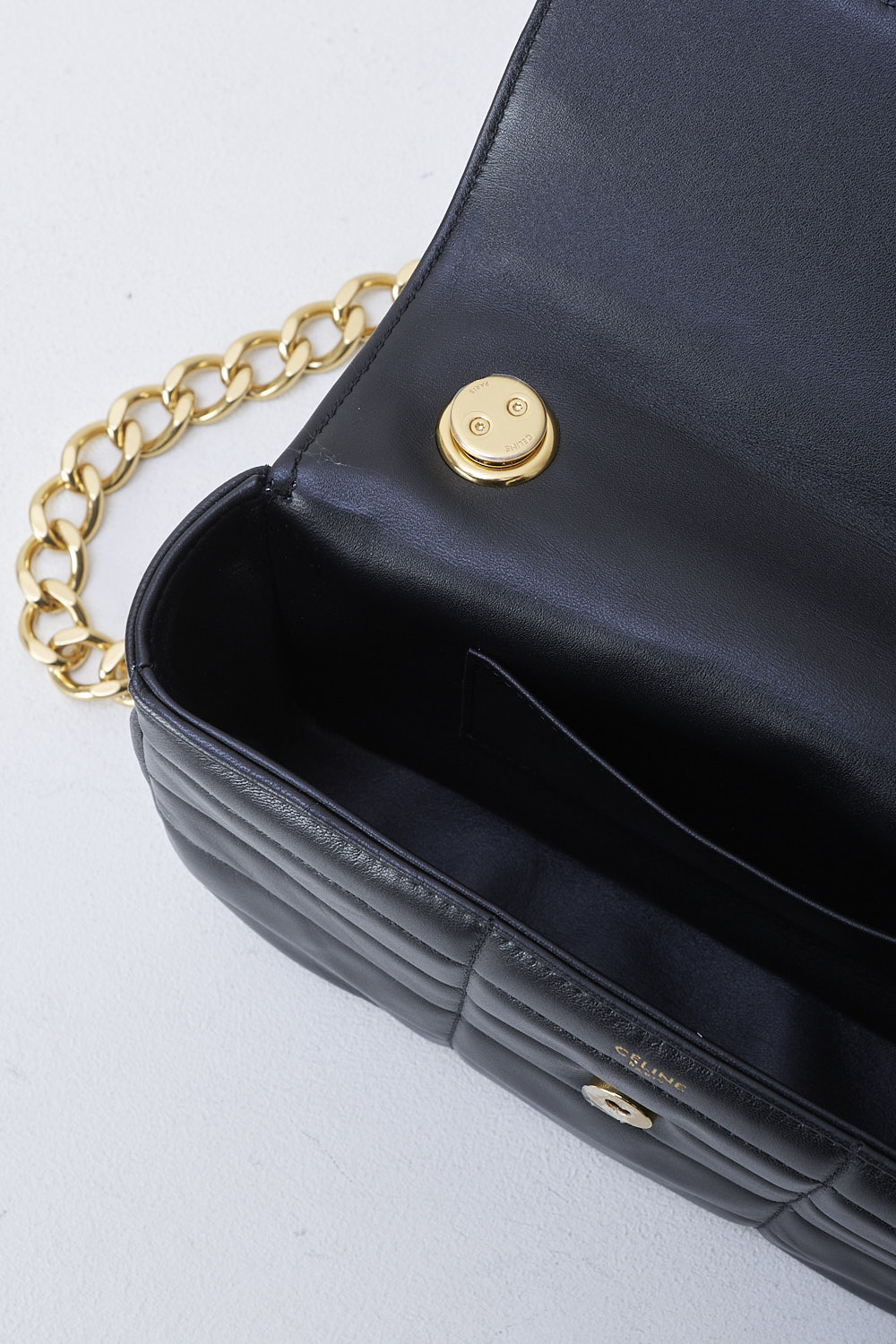 CELINE, BLACK MATELASSÃ‰ SHOULDER BAG WITH GOLD CHAIN, 111273EPZ_38NO, Black, Detail 1, This black matelassÃ© shoulder bag has gold-tone metal hardware with the brand's lettering on the front and a gold chain shoulder strap. The bag has a snap button closure. The flap opens to the main compartment with a inner pocket to the backside


