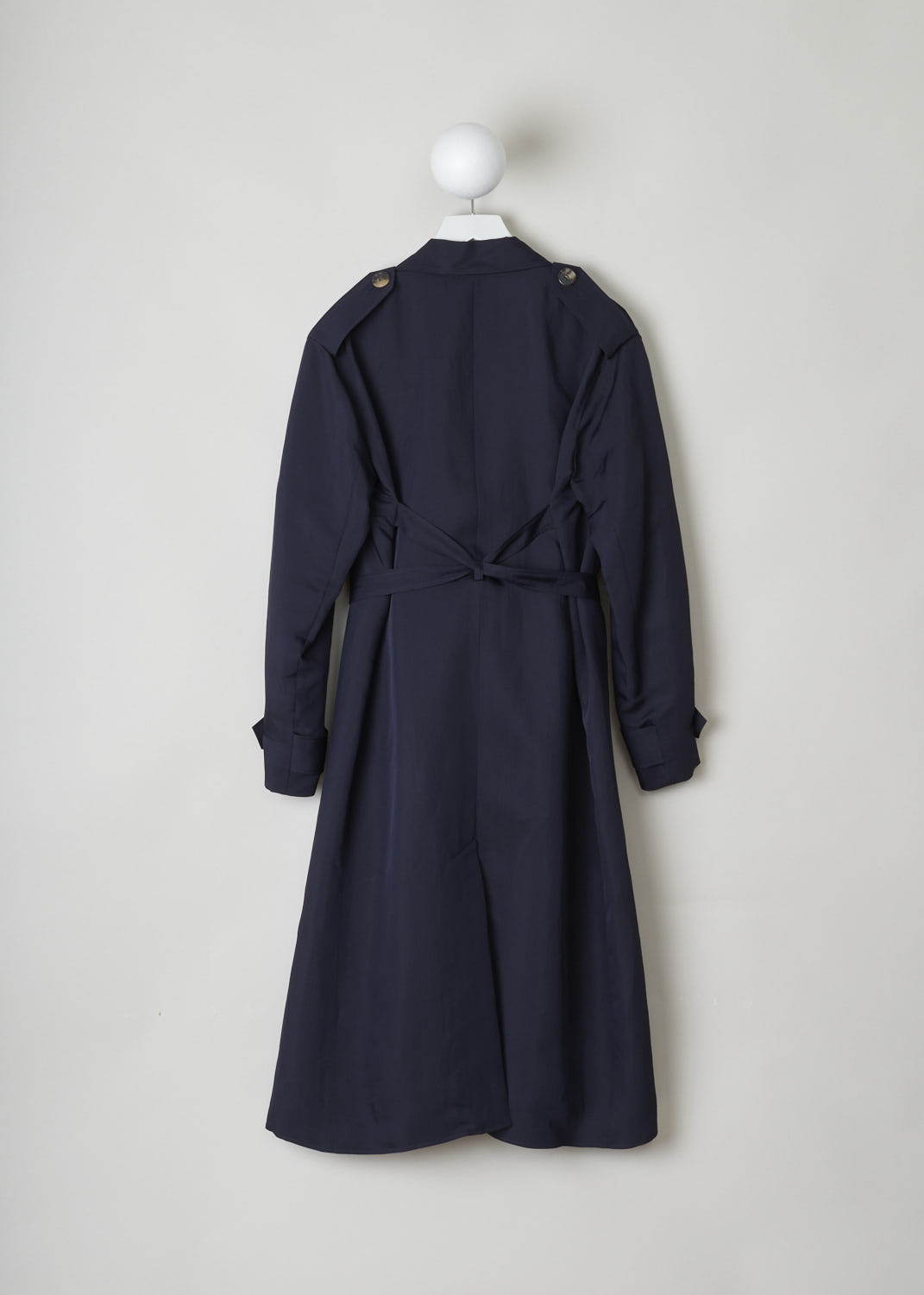CÉLINE, MIDNIGHT BLUE RAINCOAT, 6464_28U36_0MI_C01, Blue, Back, Elegant midnight blue trench coat. The coat has a notched lapel and classic details such as epaulets and storm flaps. Two rows of buttons form the closing option. The coat comes with a matching belt to cinch in the waist. The long sleeves have sleeve straps on the cuffs. A slanted pocket can be found on either side. In the back, the coat has a centre slit.