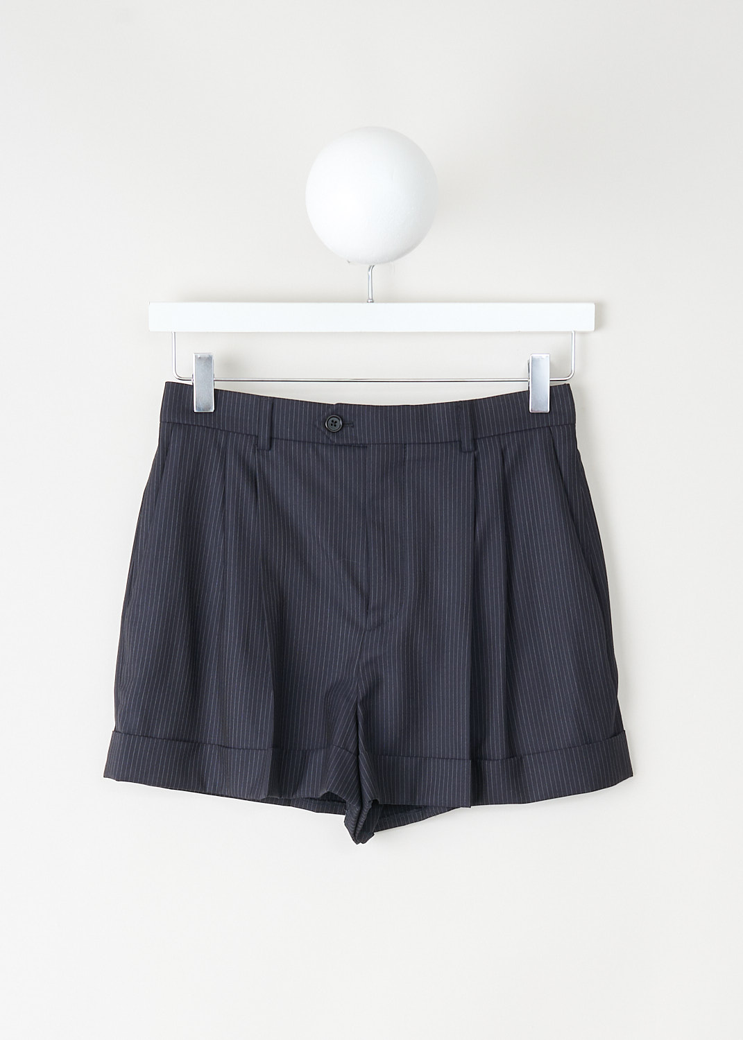 High-waisted navy blue pinstripe skate shorts in wool by Celine with belt loops, concealed button and zip closure, available at Kiki's Stocksale in Maastricht.