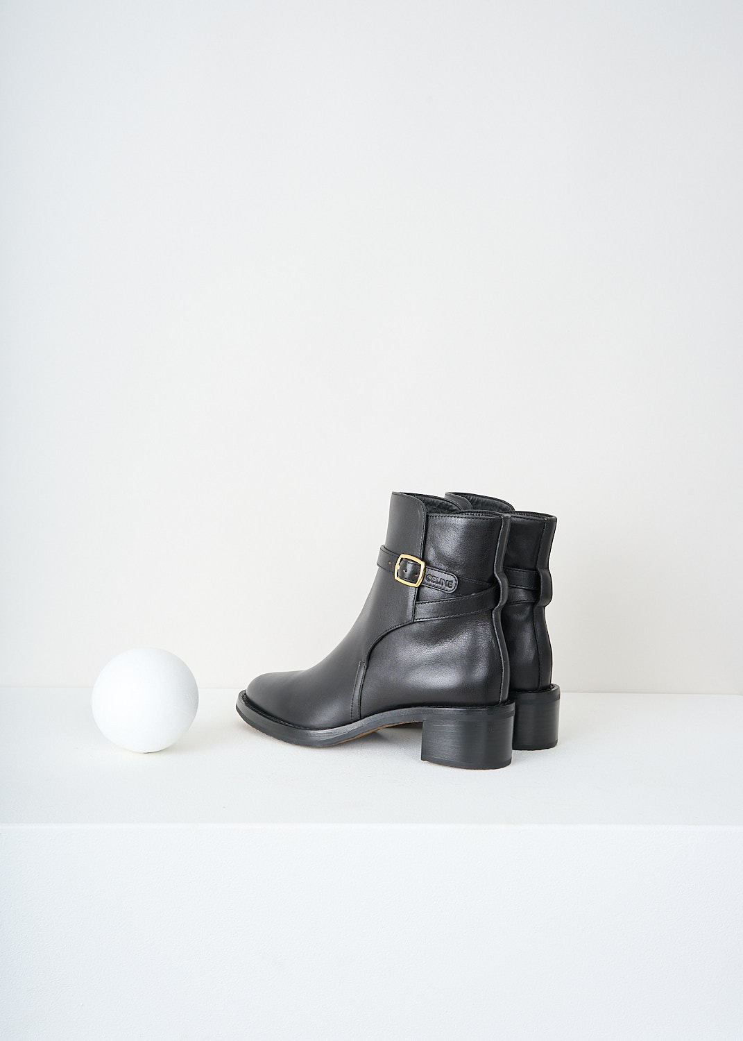 Celine, Jodhpur Ankle boots in Black, 344683190C_38NO, Black, Back, These Jodhpur Ankle boots in Black have a straps that wraps around the shaft and closes with the gold-tone buckle on the outside of the leg. These boots have a round toe and a small block heel.
