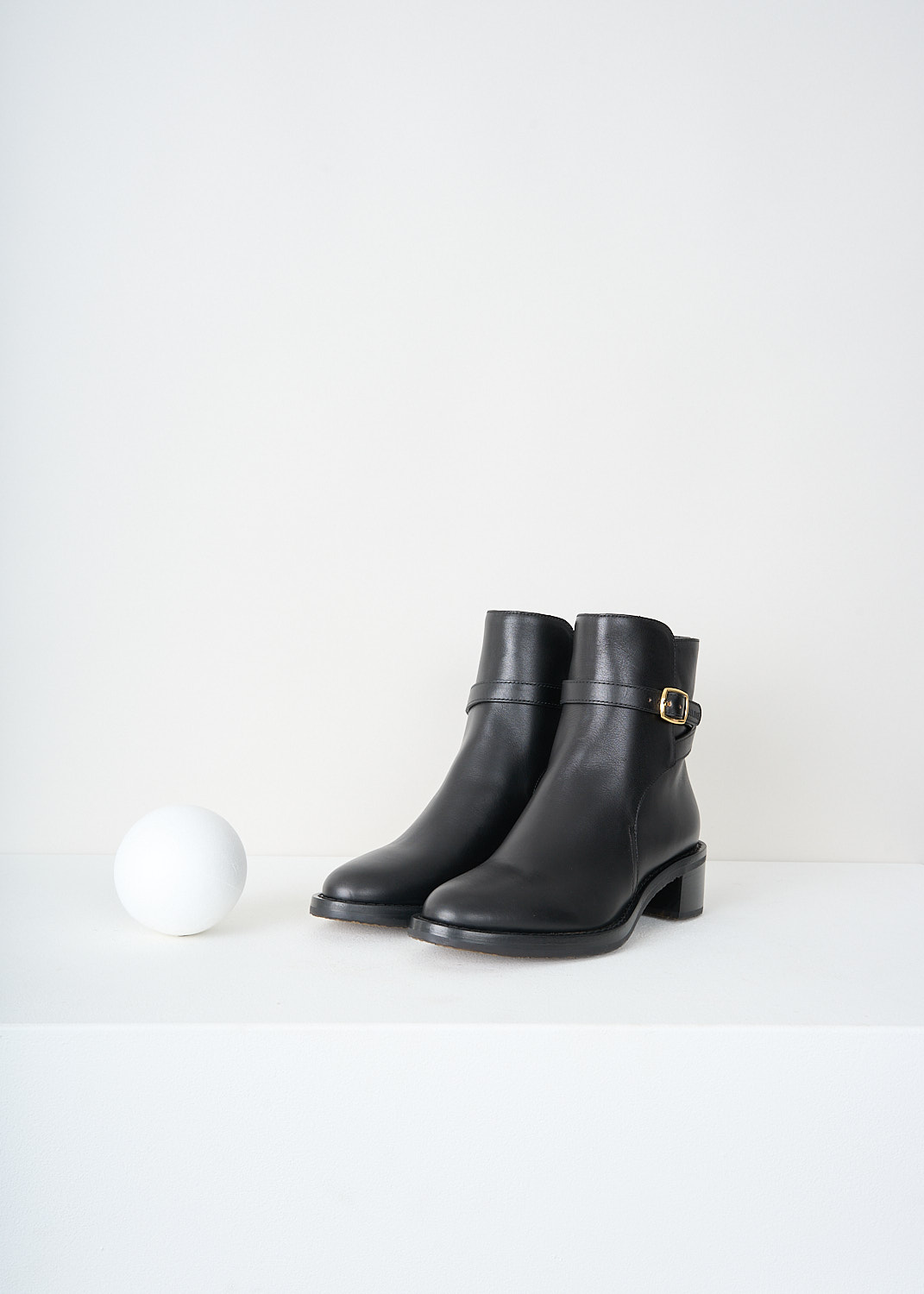 Celine, Jodhpur Ankle boots in Black, 344683190C_38NO, Black, Front, These Jodhpur Ankle boots in Black have a straps that wraps around the shaft and closes with the gold-tone buckle on the outside of the leg. These boots have a round toe and a small block heel.
