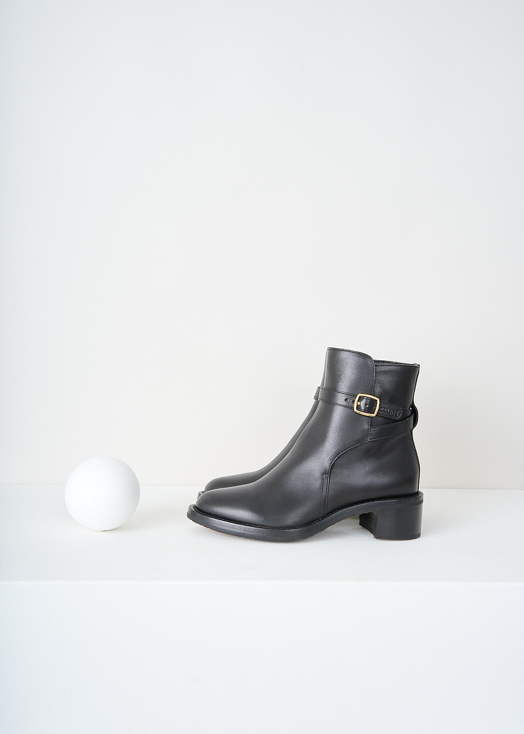 Celine, Jodhpur Ankle boots in Black, 344683190C_38NO, Black, Side, These Jodhpur Ankle boots in Black have a straps that wraps around the shaft and closes with the gold-tone buckle on the outside of the leg. These boots have a round toe and a small block heel.
