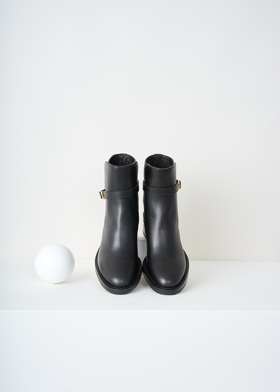 Celine, Jodhpur Ankle boots in Black, 344683190C_38NO, Black, Top, These Jodhpur Ankle boots in Black have a straps that wraps around the shaft and closes with the gold-tone buckle on the outside of the leg. These boots have a round toe and a small block heel.
