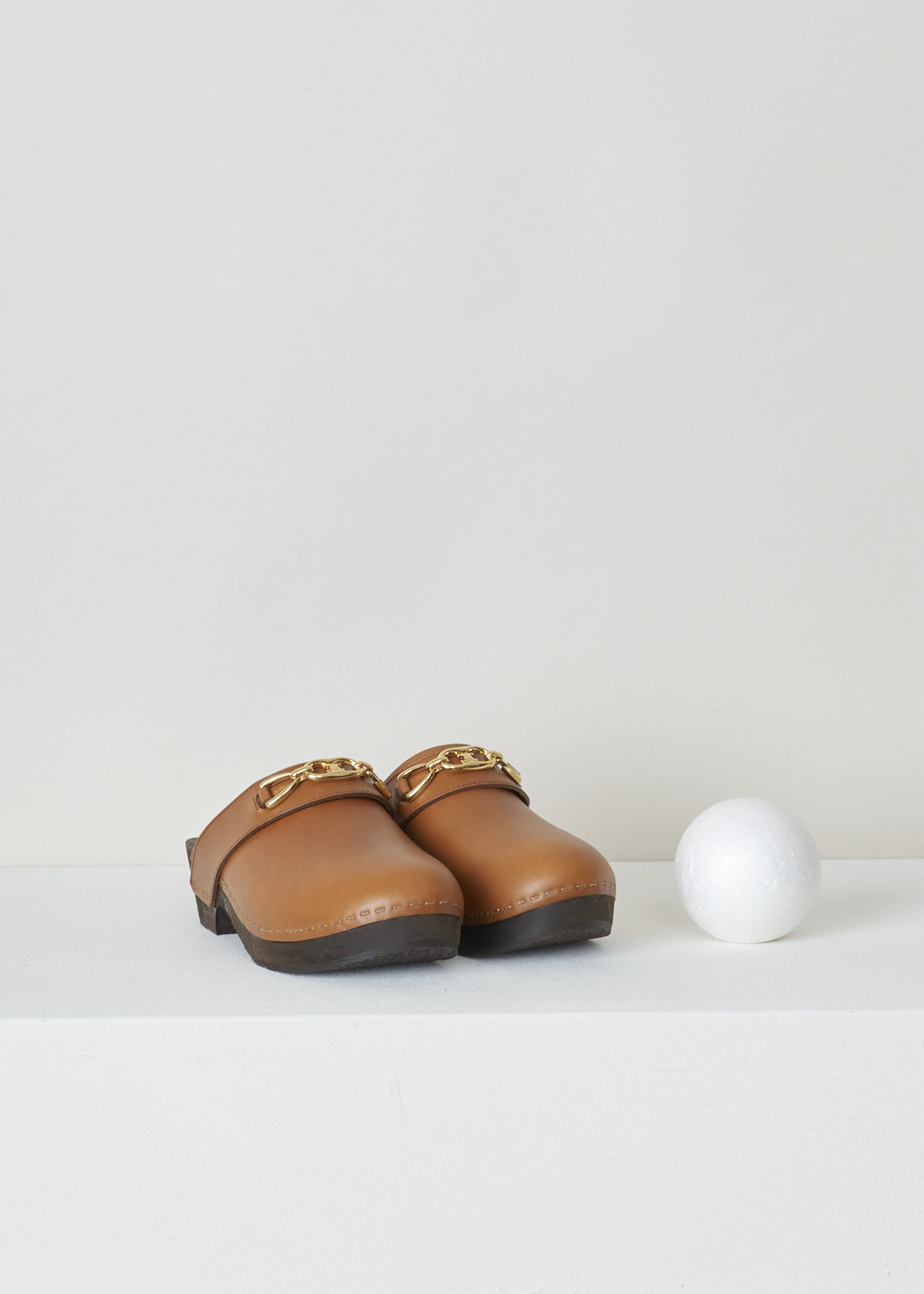 celine, Les bois cognac coloured clogs, 336623363C_04LU, brown, front, Cognac coloured clogs featuring a round toe vamp which is decorated with this brands signature Maillon Triomphe metal chain. Another lovely little detail about these clogs are the hand painted basswood soles. 
