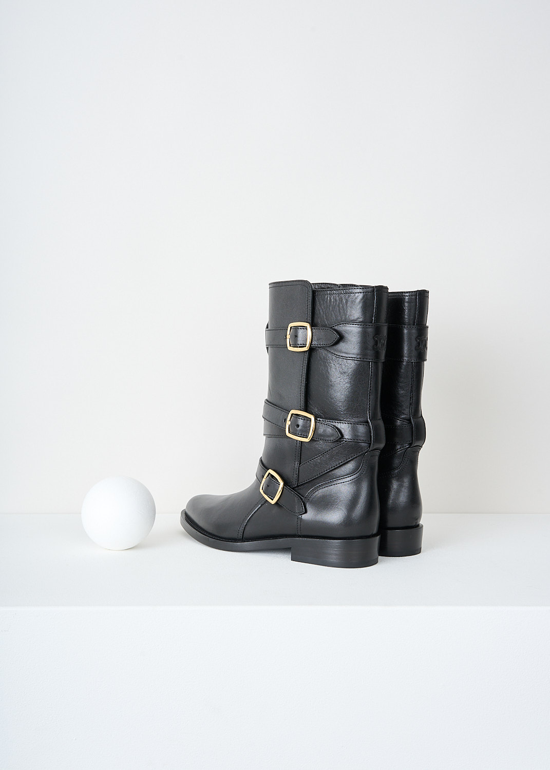 Celine, Triple buckle biker boot in Black, 35498_3492C_38NO_F, Black, Back, These black biker boot have three straps with gold-tine buckles around the shaft. These boots have a almond toe and a small heel.

heel height: 2 cm / 0.7 inch
