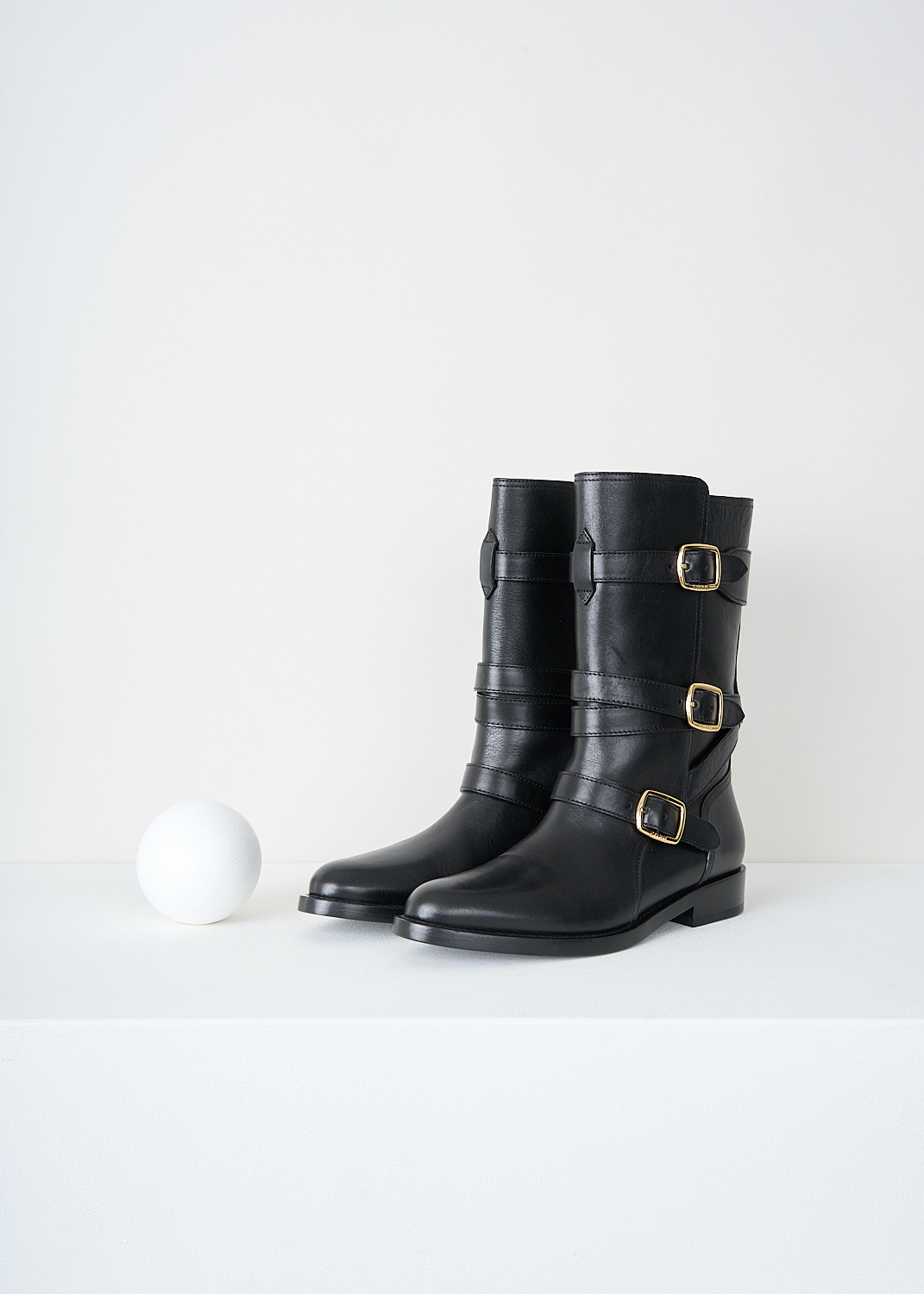 Celine, Triple buckle biker boot in Black, 35498_3492C_38NO_F, Black, Front, These black biker boot have three straps with gold-tine buckles around the shaft. These boots have a almond toe and a small heel.

heel height: 2 cm / 0.7 inch
