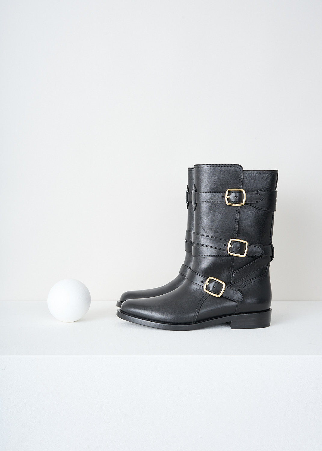 Celine, Triple buckle biker boot in Black, 35498_3492C_38NO_F, Black, Side, These black biker boot have three straps with gold-tine buckles around the shaft. These boots have a almond toe and a small heel.

heel height: 2 cm / 0.7 inch
