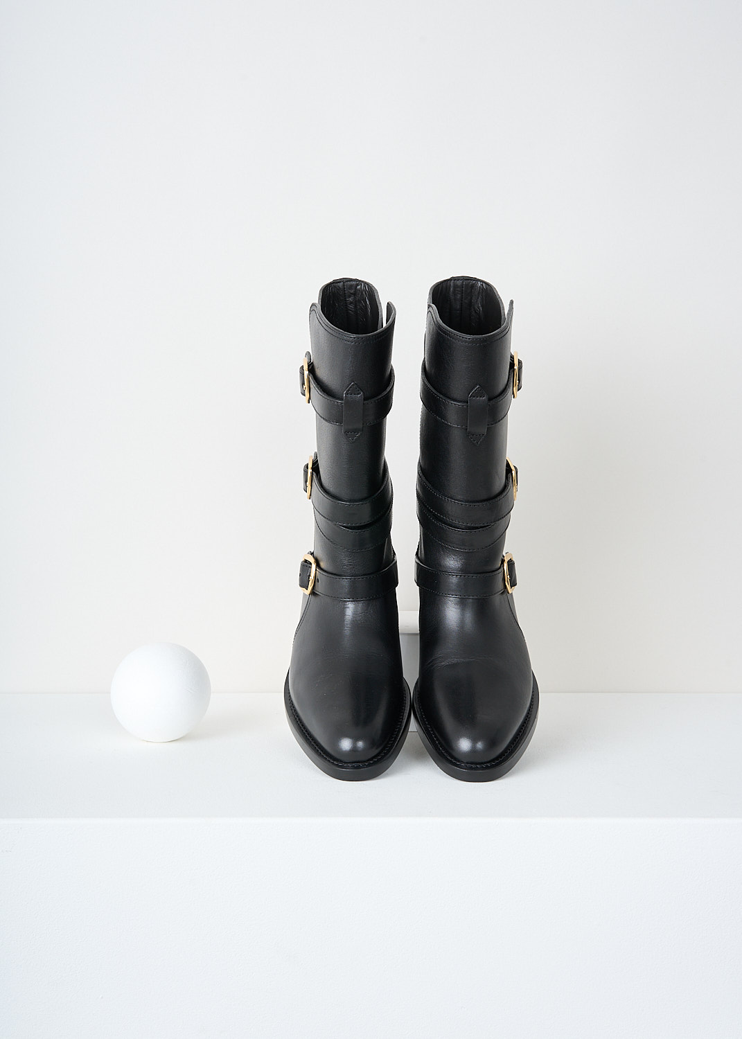 Celine, Triple buckle biker boot in Black, 35498_3492C_38NO_F, Black, Top, These black biker boot have three straps with gold-tine buckles around the shaft. These boots have a almond toe and a small heel.

heel height: 2 cm / 0.7 inch
