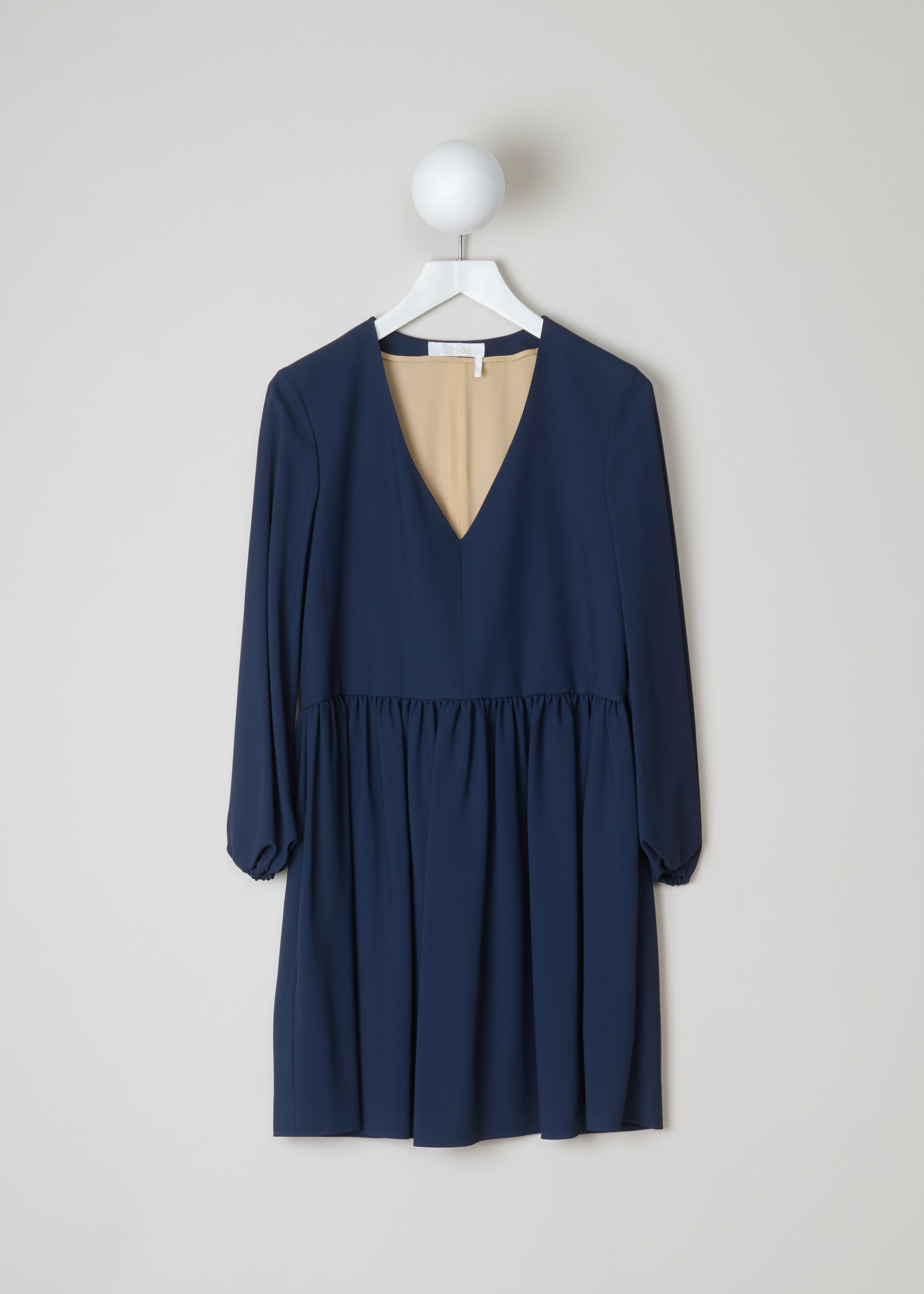 ChloÃ© Gathered deep blue dress 17SRO65_17S37_7B5 deep blue front. Deep blue dress with a V-neck. This model has loose sleeves and gathered cuffs. The straight cut has small pleats around the waist and a midi length. As closure this dress has an invisible zipper on the side.