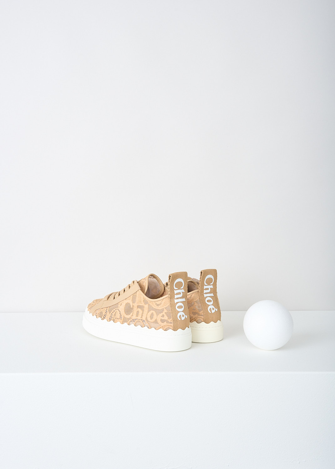 Chloé, Biscotti beige lace Lauren sneakers, CHC19U108D2268_BISCOTTI_BEIGE, Beige, Back, These Biscotti beige lace low-top Lauren sneakers have a lace closure. The white sole has a scalloped edge. These sneakers have a matching pull tab on the heel.
